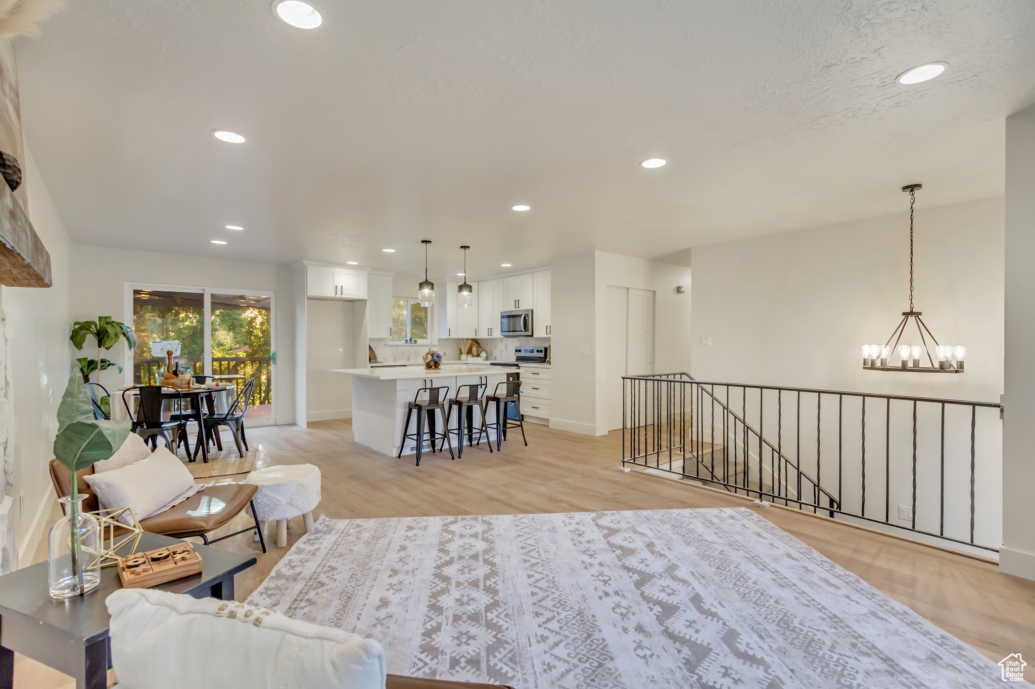 Living room with light hardwood / wood-style flooring and a chandelier