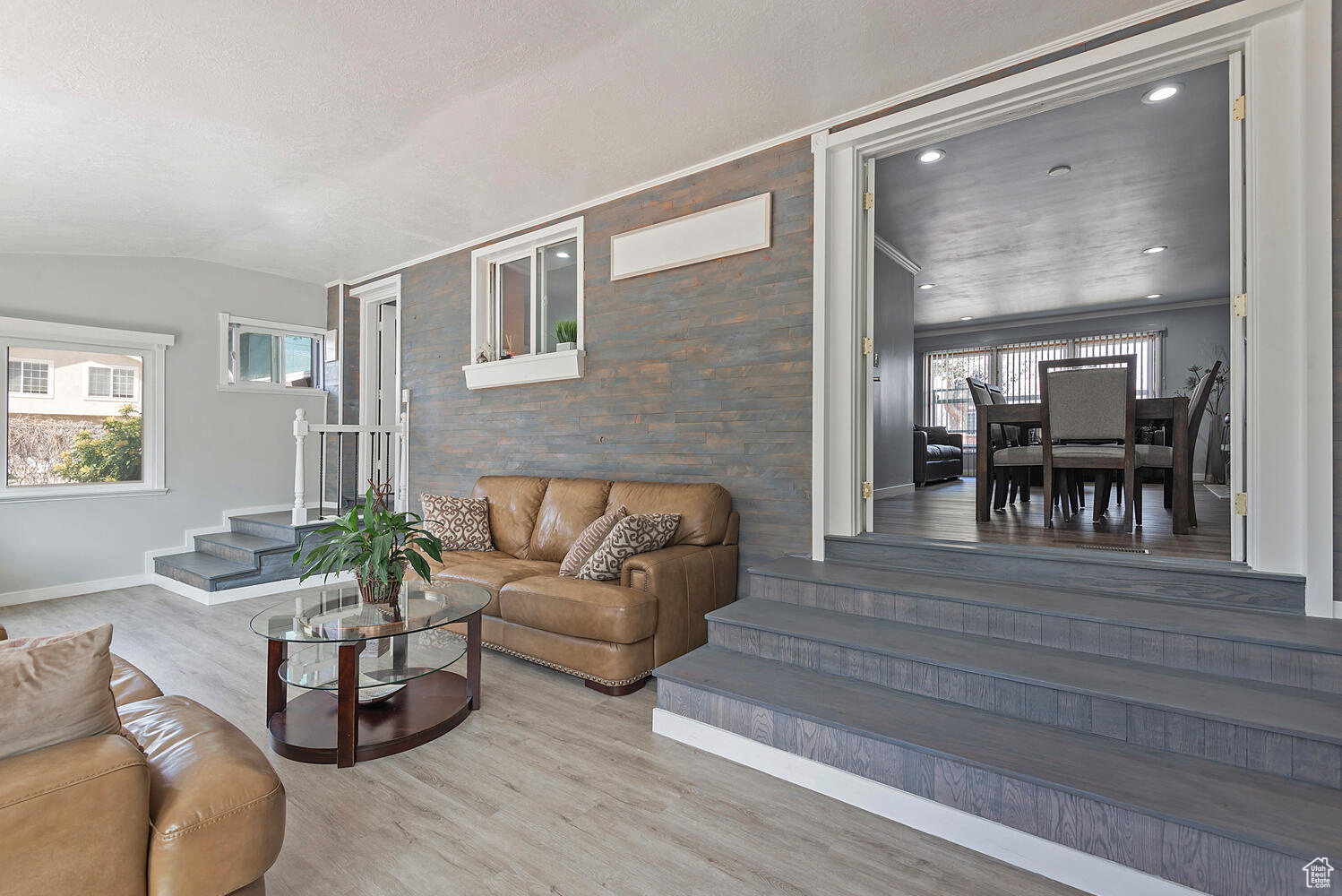 Living room with lofted ceiling, hardwood / wood-style floors, and a healthy amount of sunlight