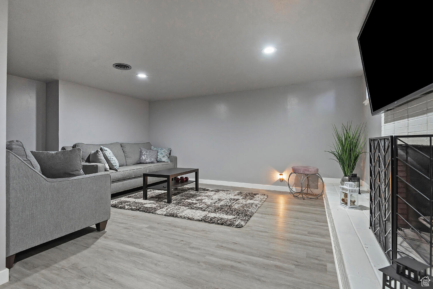 Living room featuring a tile fireplace and light hardwood / wood-style floors