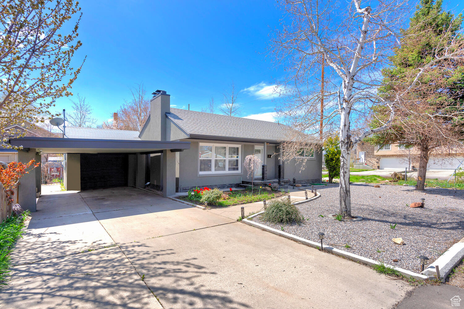 Ranch-style house featuring a carport