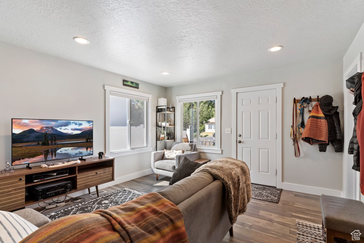 Living room featuring a textured ceiling and hardwood / wood-style floors