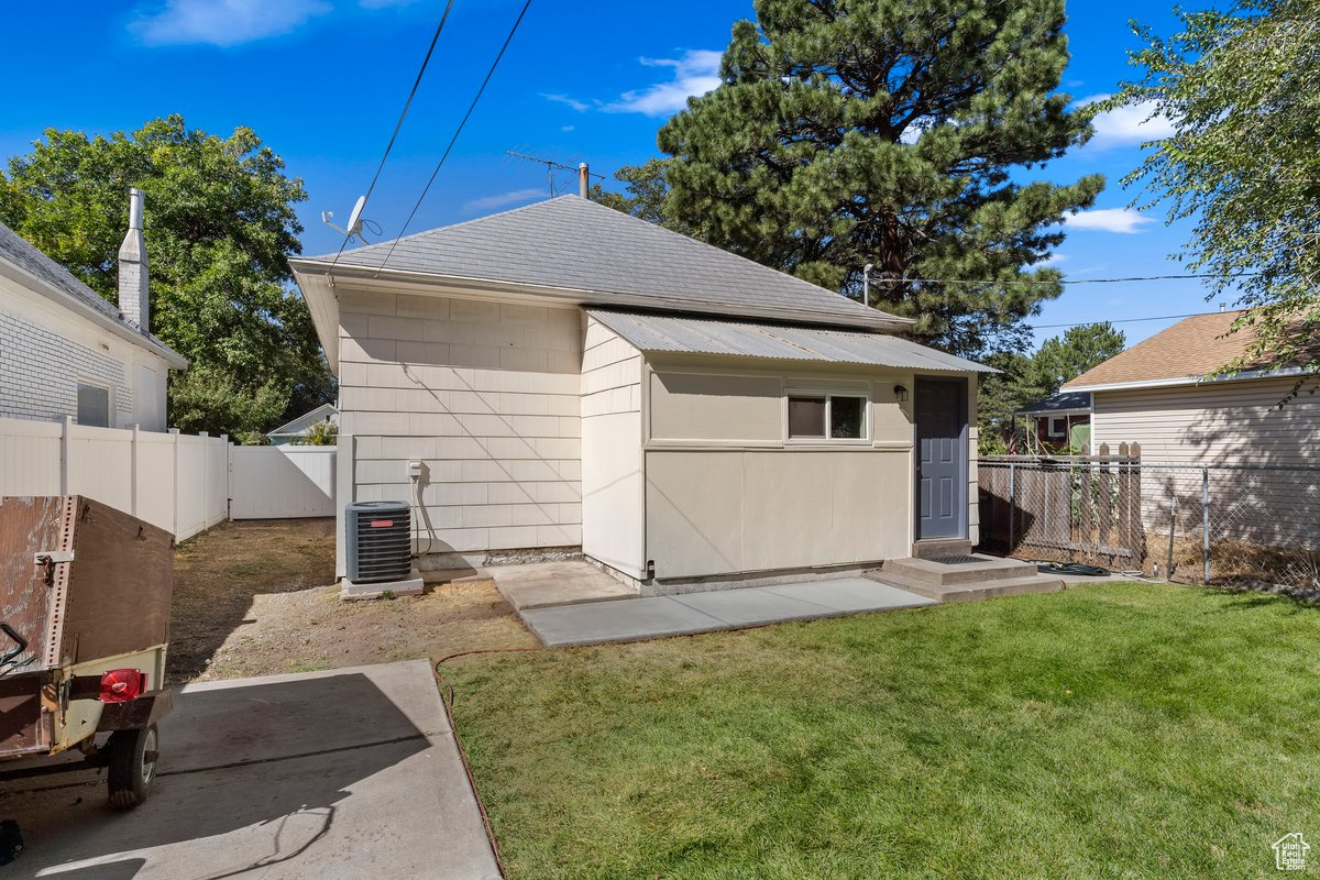 Exterior space featuring a lawn and central AC