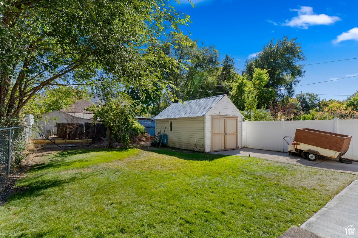 View of yard with a patio and a shed