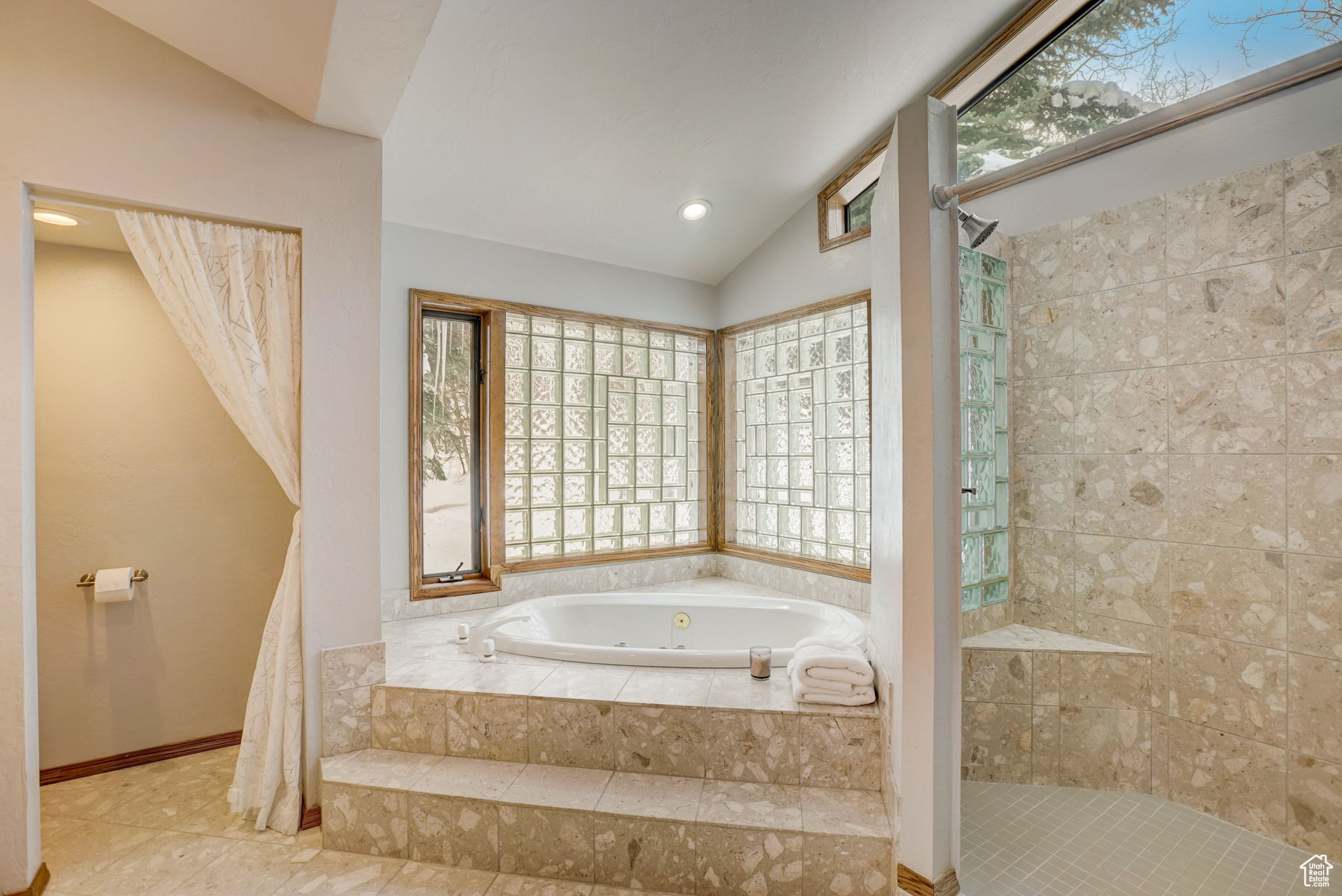 Bathroom featuring lofted ceiling and independent shower and bath