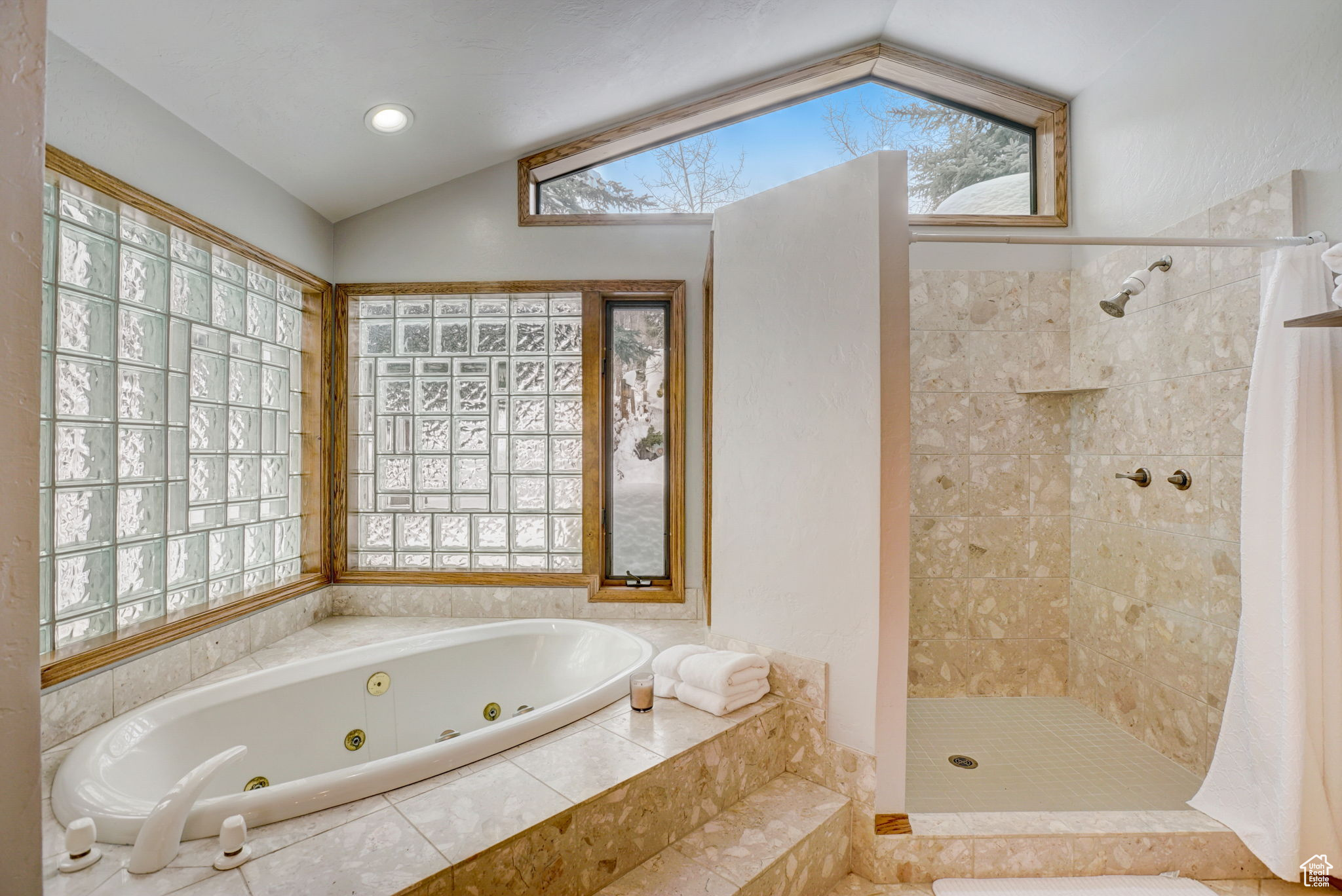 Bathroom featuring independent shower and bath and vaulted ceiling