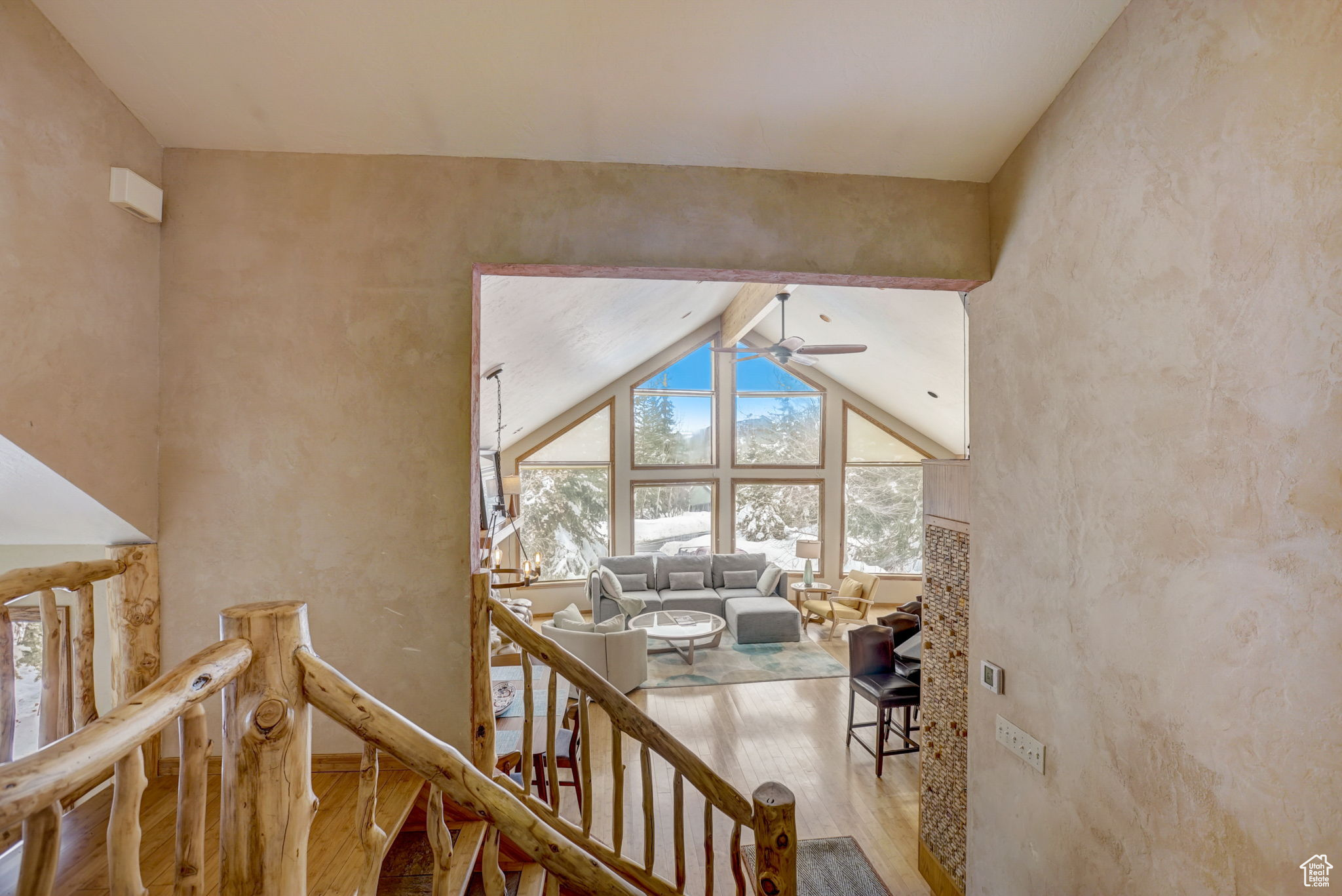 Hall with beamed ceiling, hardwood / wood-style flooring, and high vaulted ceiling