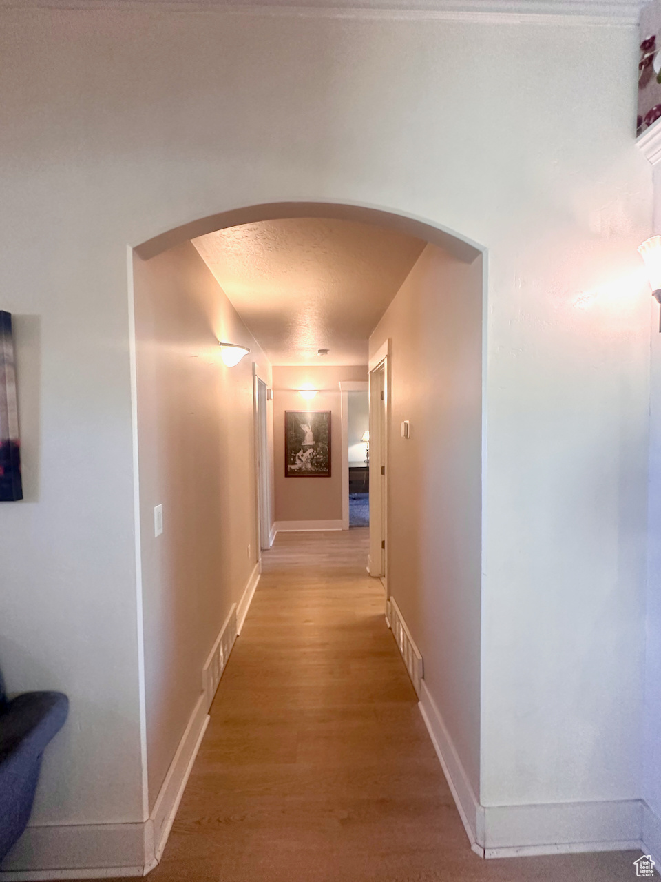 Hall featuring a textured ceiling and hardwood / wood-style flooring