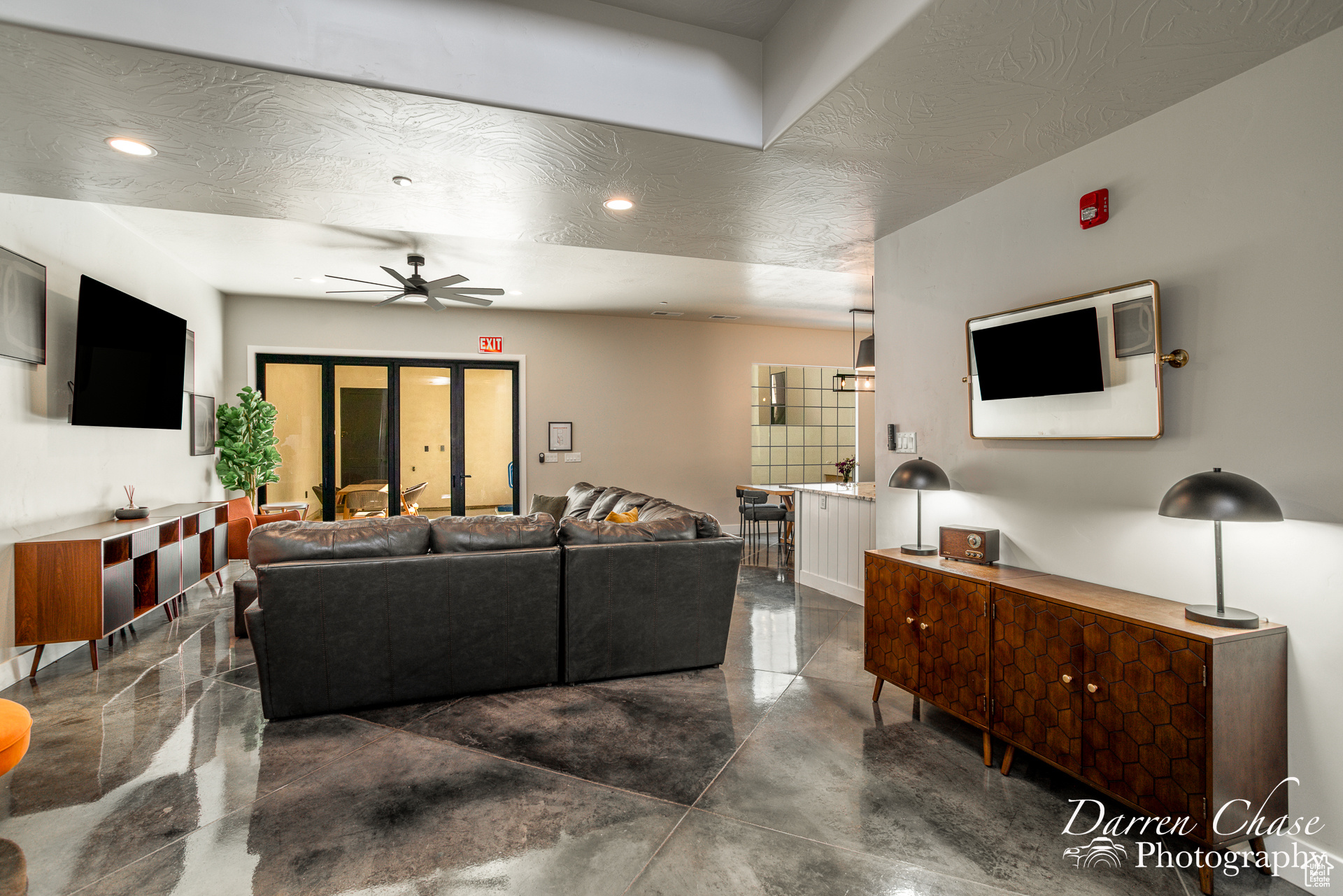 Living room with ceiling fan and a textured ceiling