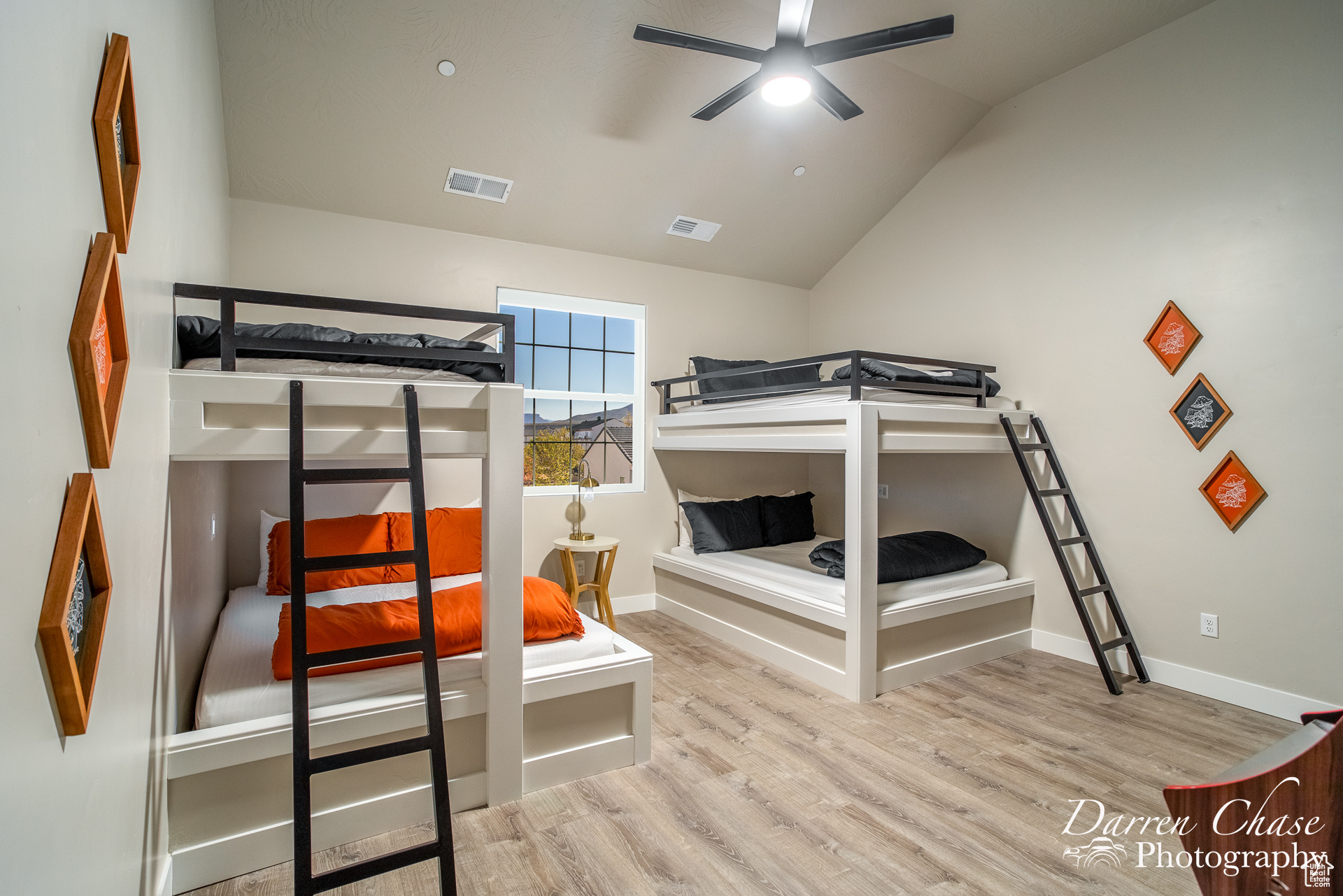 Bedroom featuring light wood-type flooring and lofted ceiling