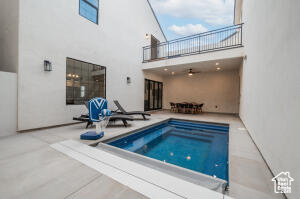 View of pool with a jacuzzi and a patio area