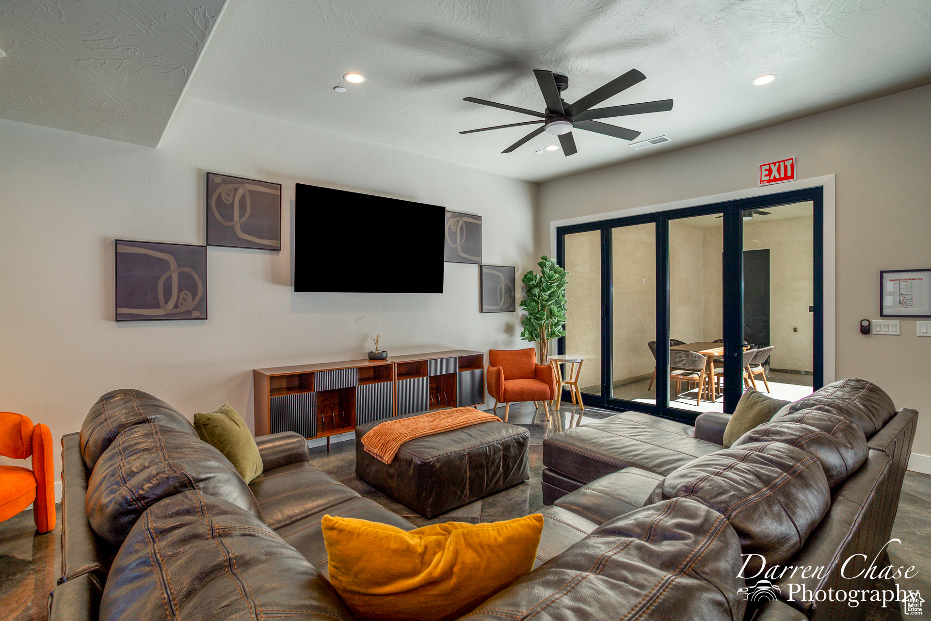 Living room featuring wood-type flooring, ceiling fan, french doors, and a textured ceiling