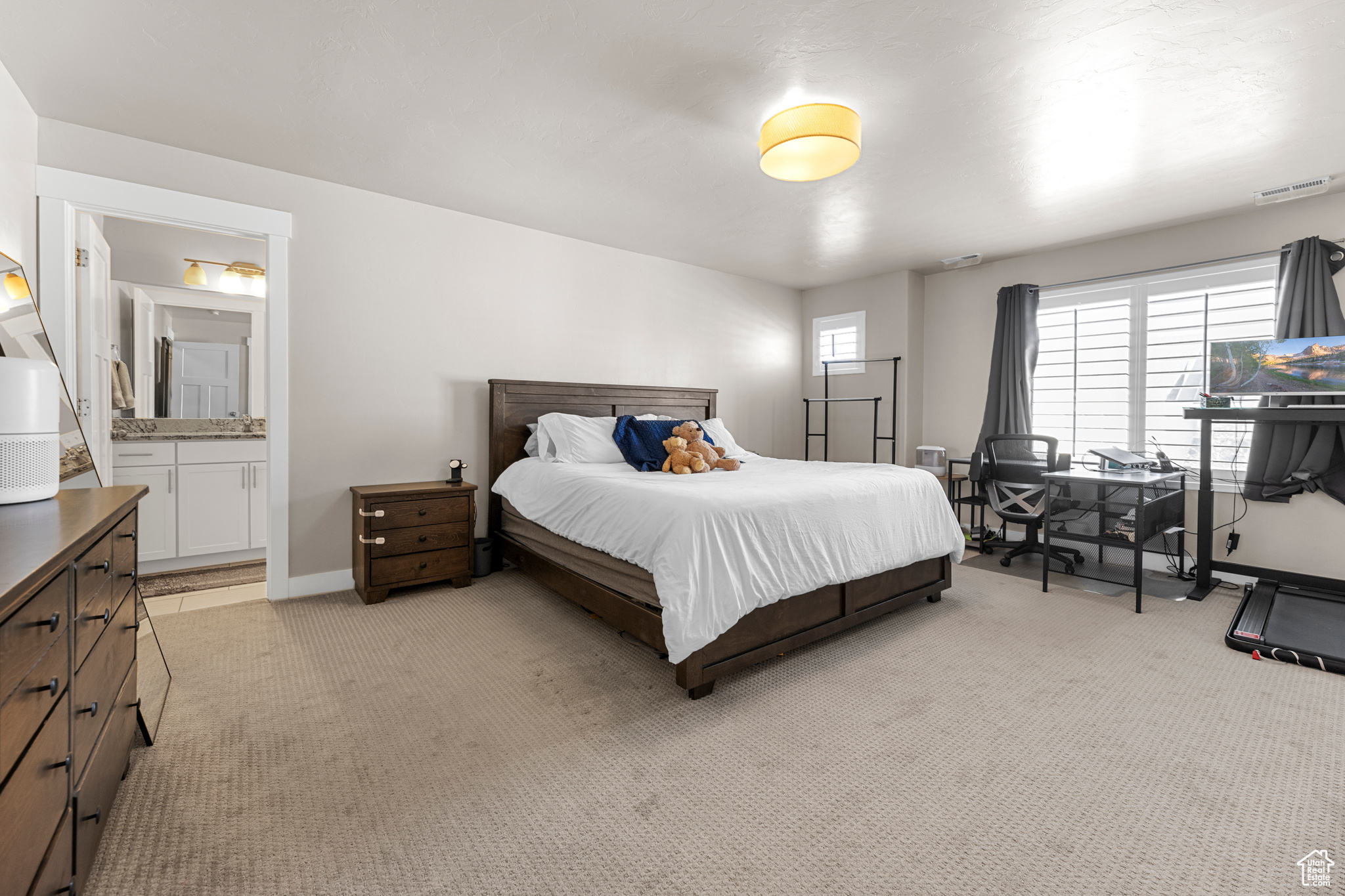 Carpeted bedroom with ensuite bathroom