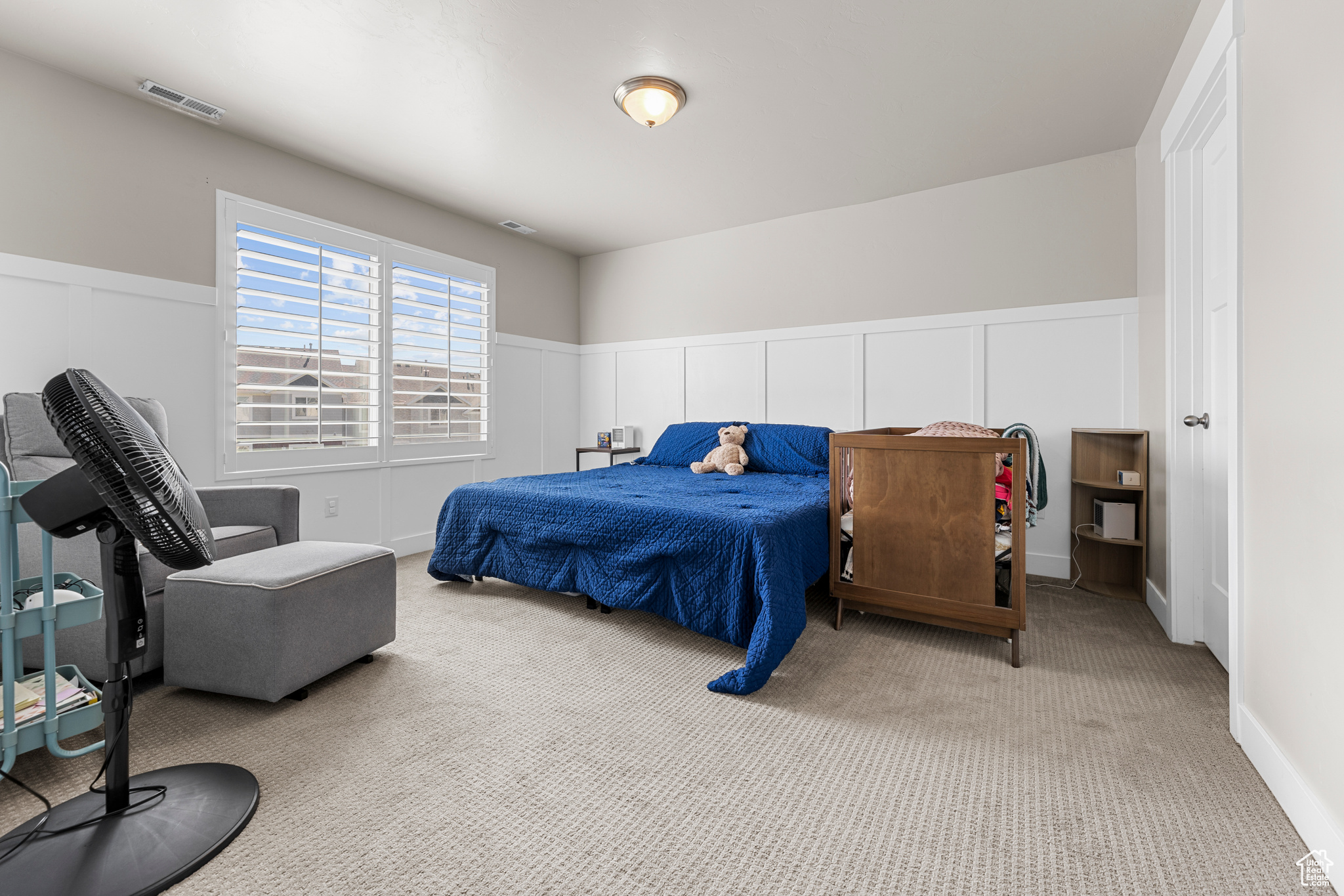 Bedroom with light colored carpet