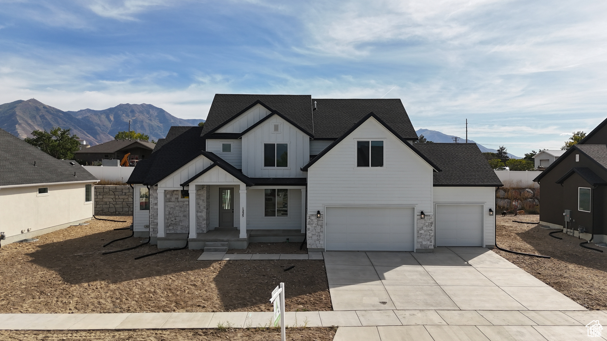 View of front facade with a garage and a mountain view