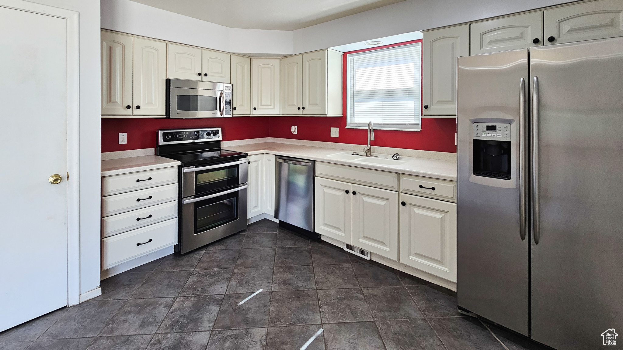 Kitchen with appliances with stainless steel finishes and sink