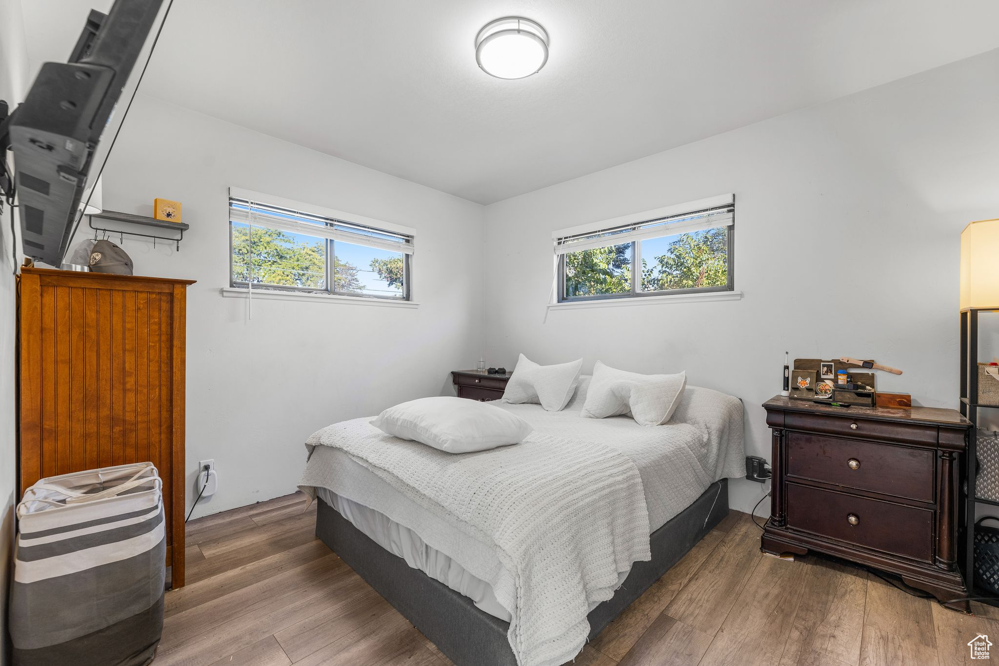 Bedroom with multiple windows and hardwood / wood-style flooring