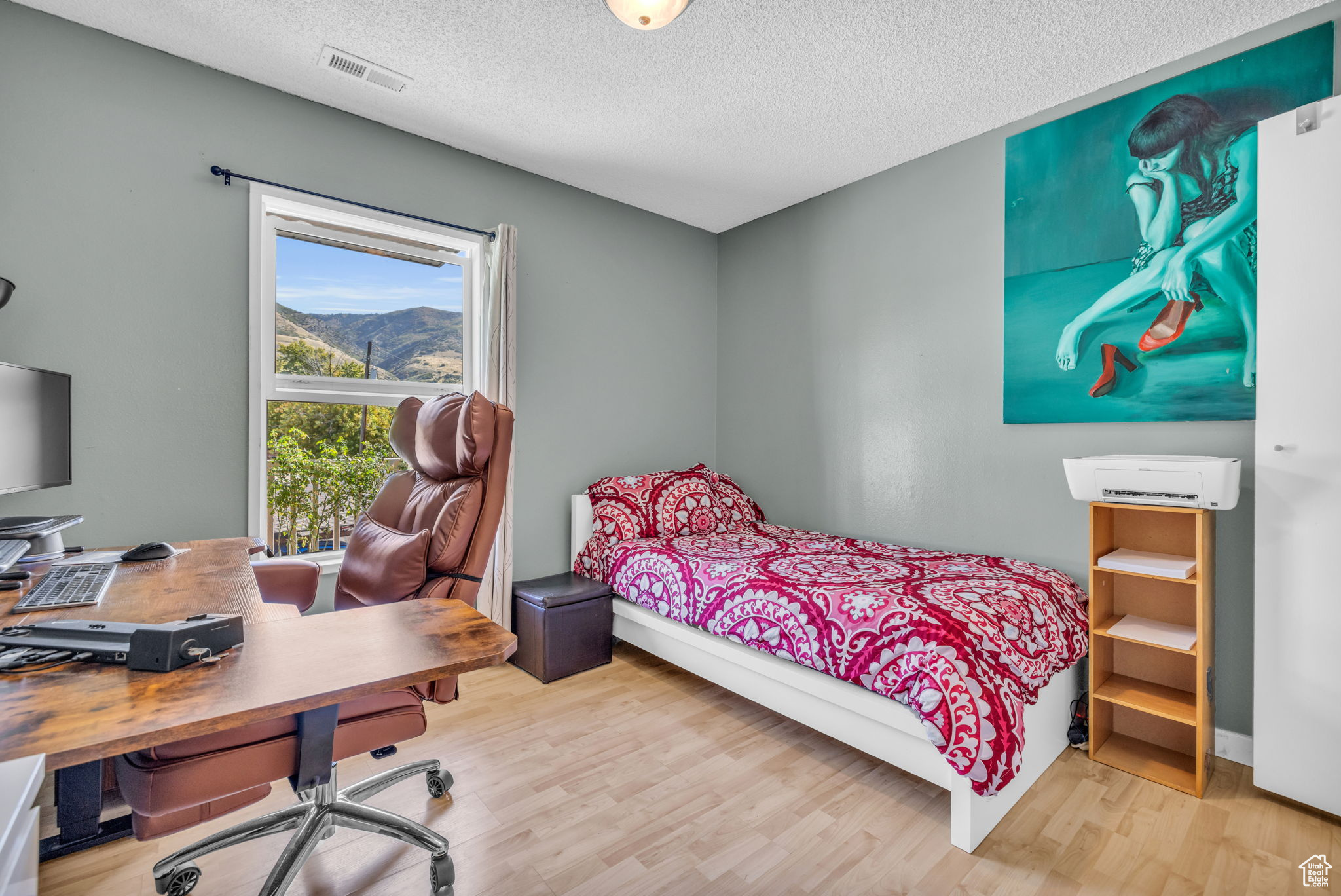 Bedroom featuring a textured ceiling and hardwood / wood-style floors