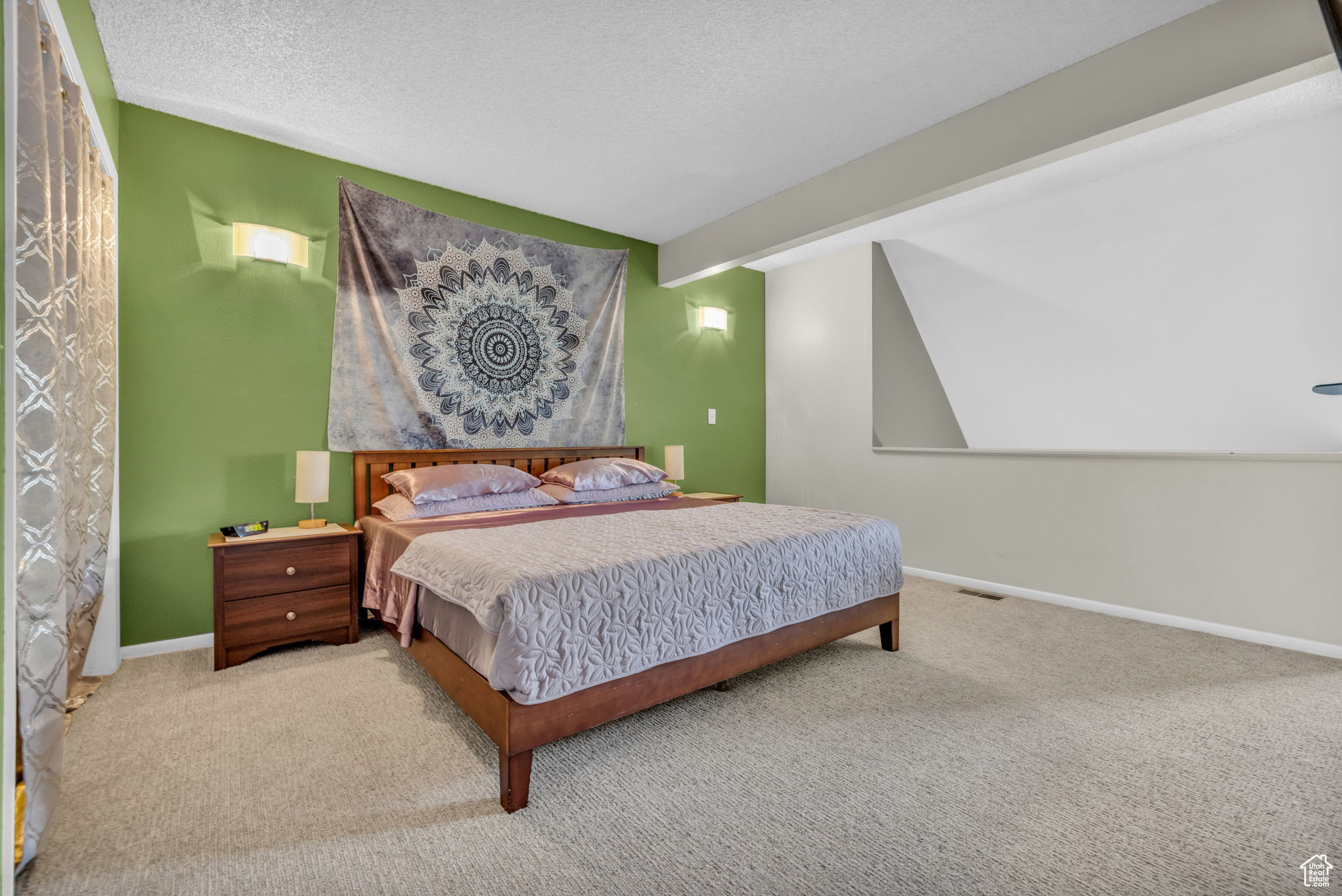 Carpeted bedroom with a textured ceiling