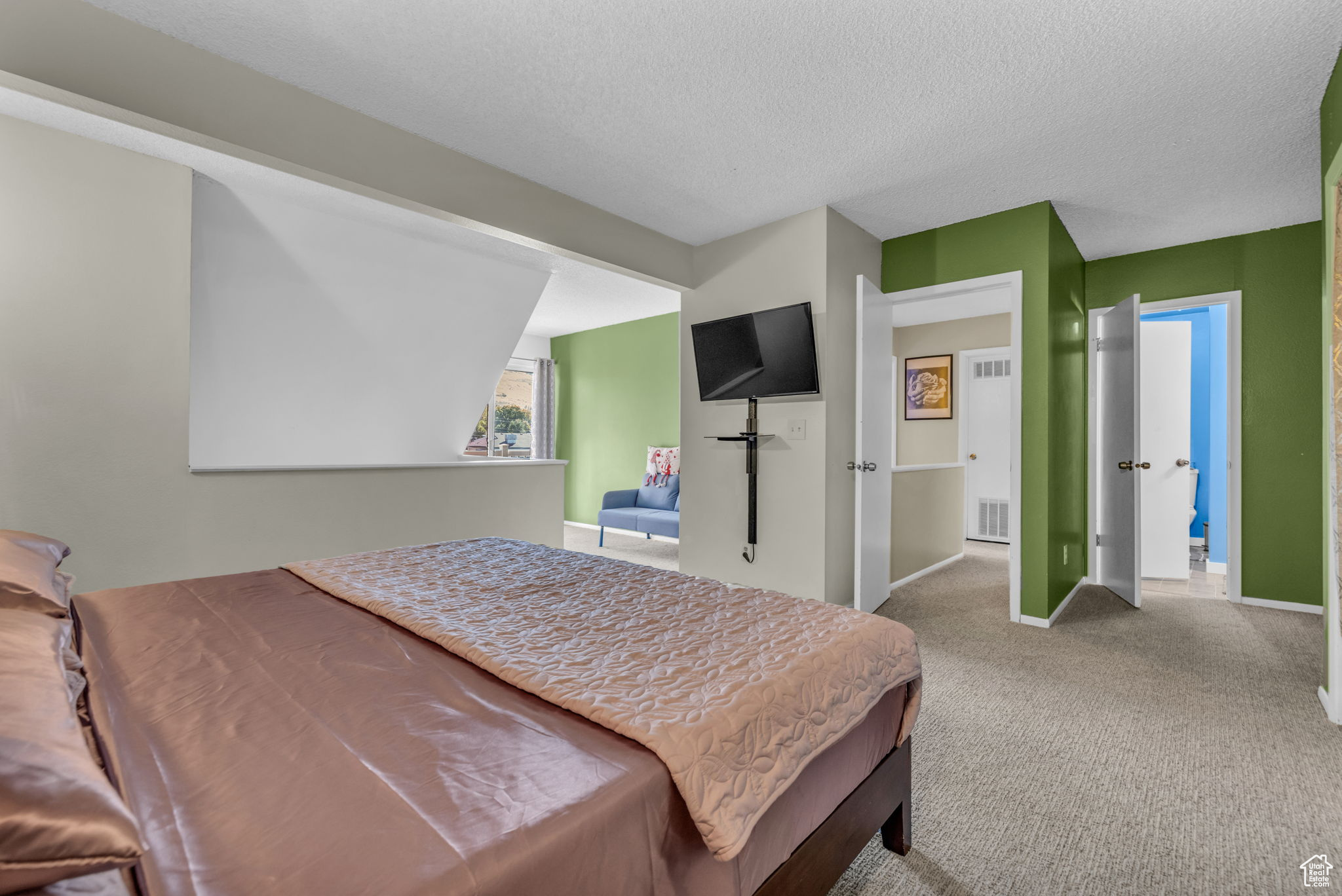 Carpeted bedroom featuring a textured ceiling