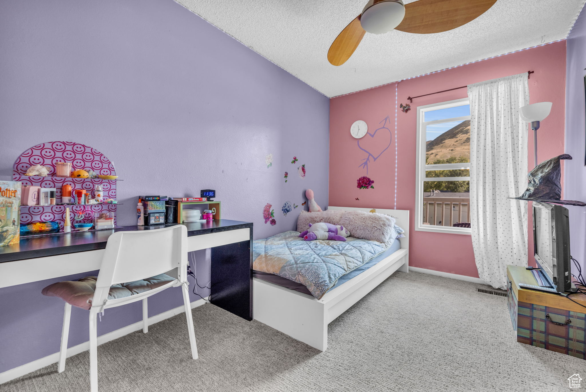 Bedroom with ceiling fan, a textured ceiling, and carpet