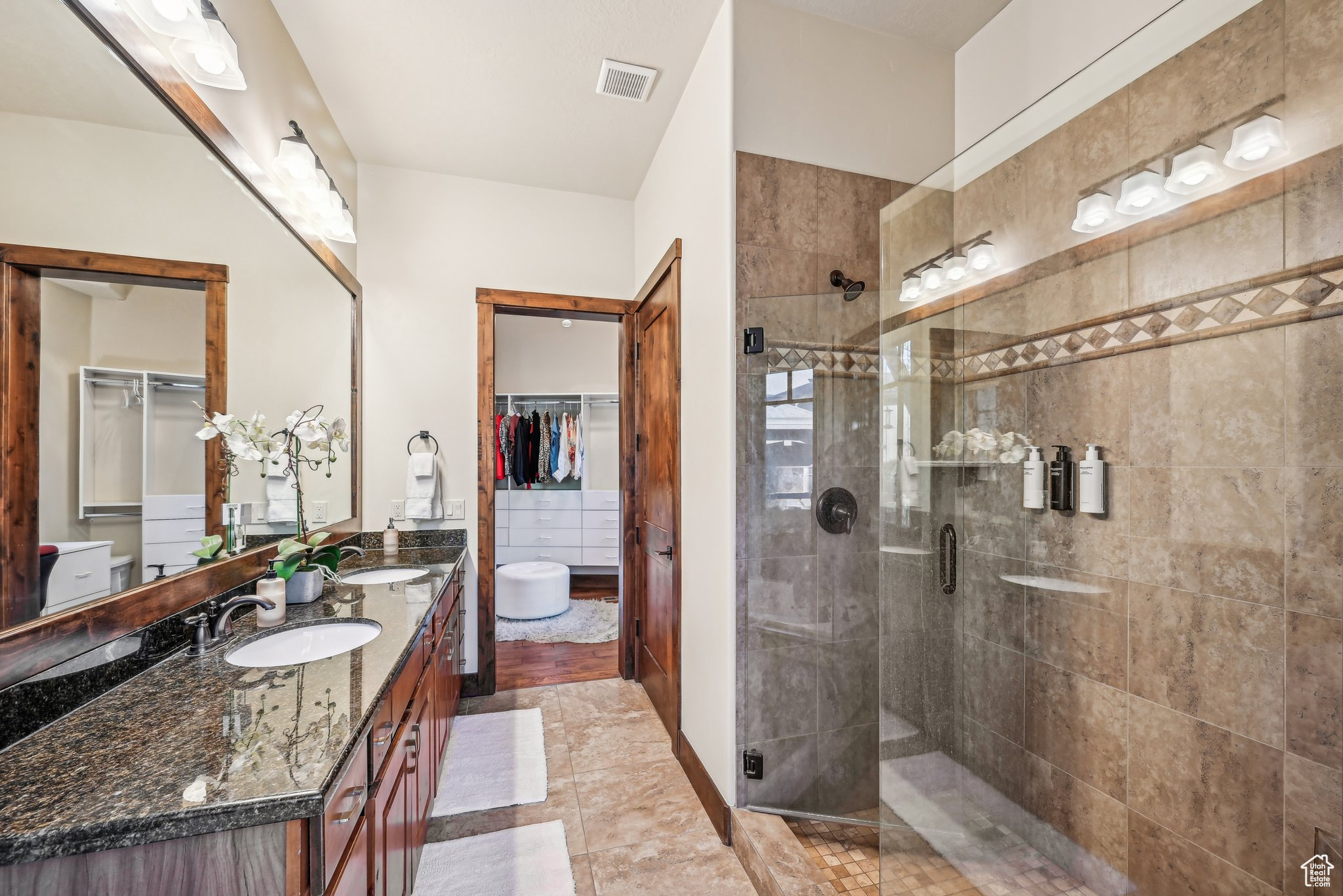 Bathroom with tile patterned flooring, vanity, and an enclosed shower