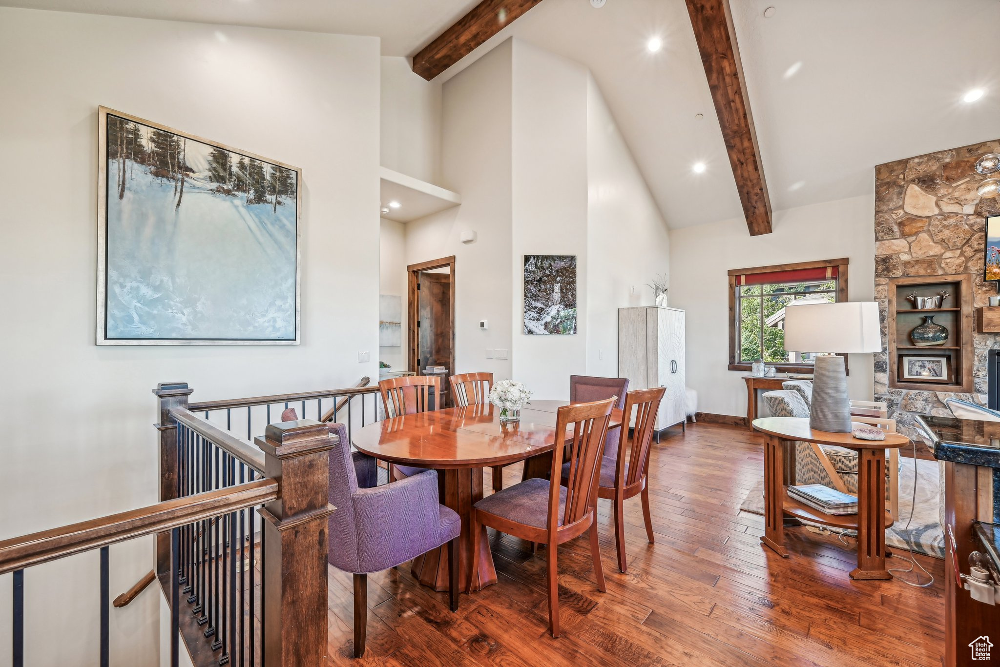 Dining space featuring beamed ceiling, hardwood / wood-style flooring, and high vaulted ceiling