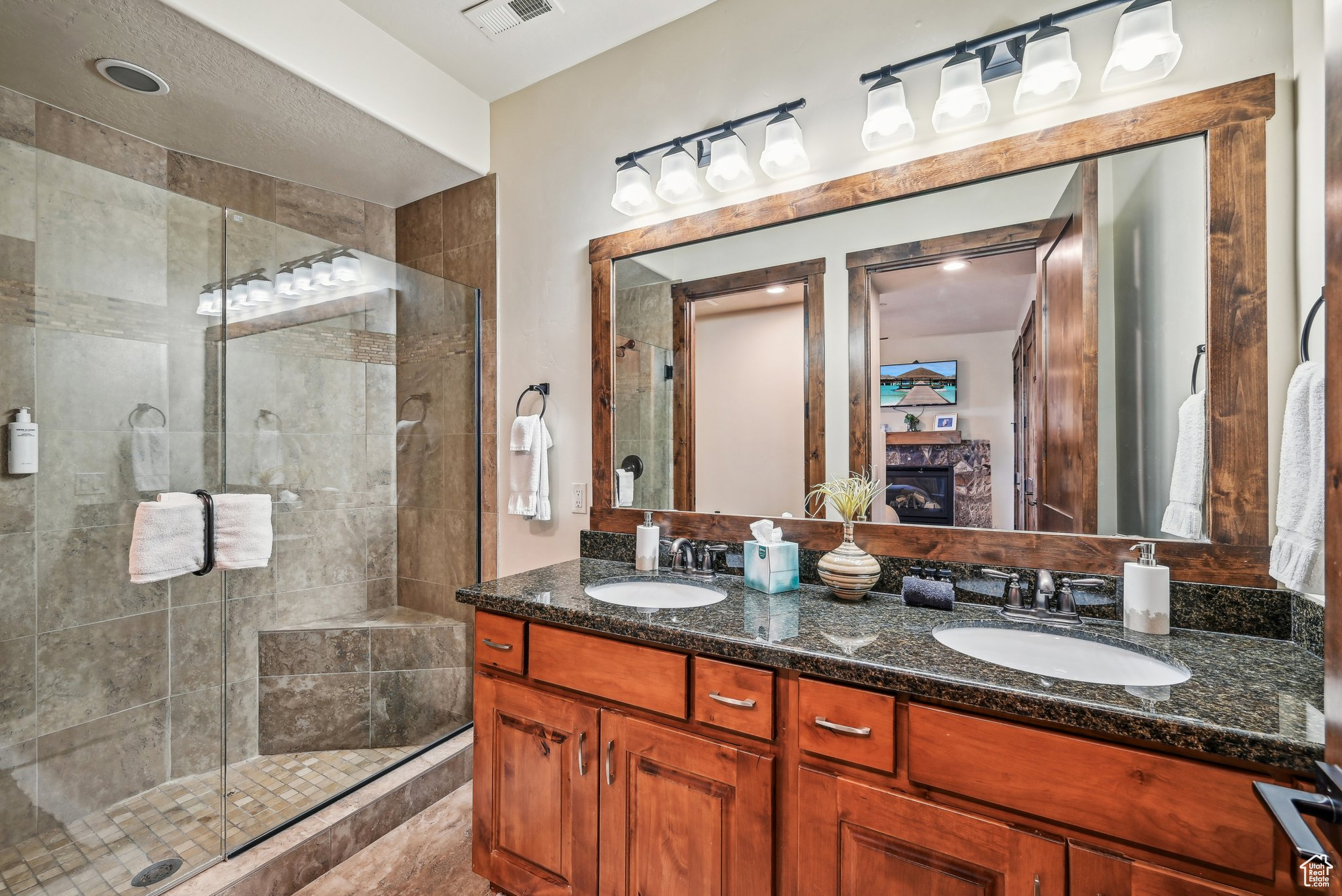 Bathroom featuring vanity and an enclosed shower