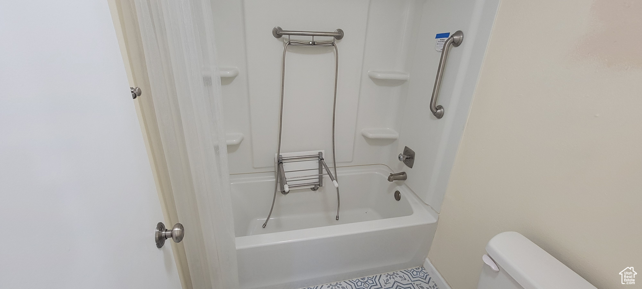 Bathroom featuring bathing tub / shower combination and toilet