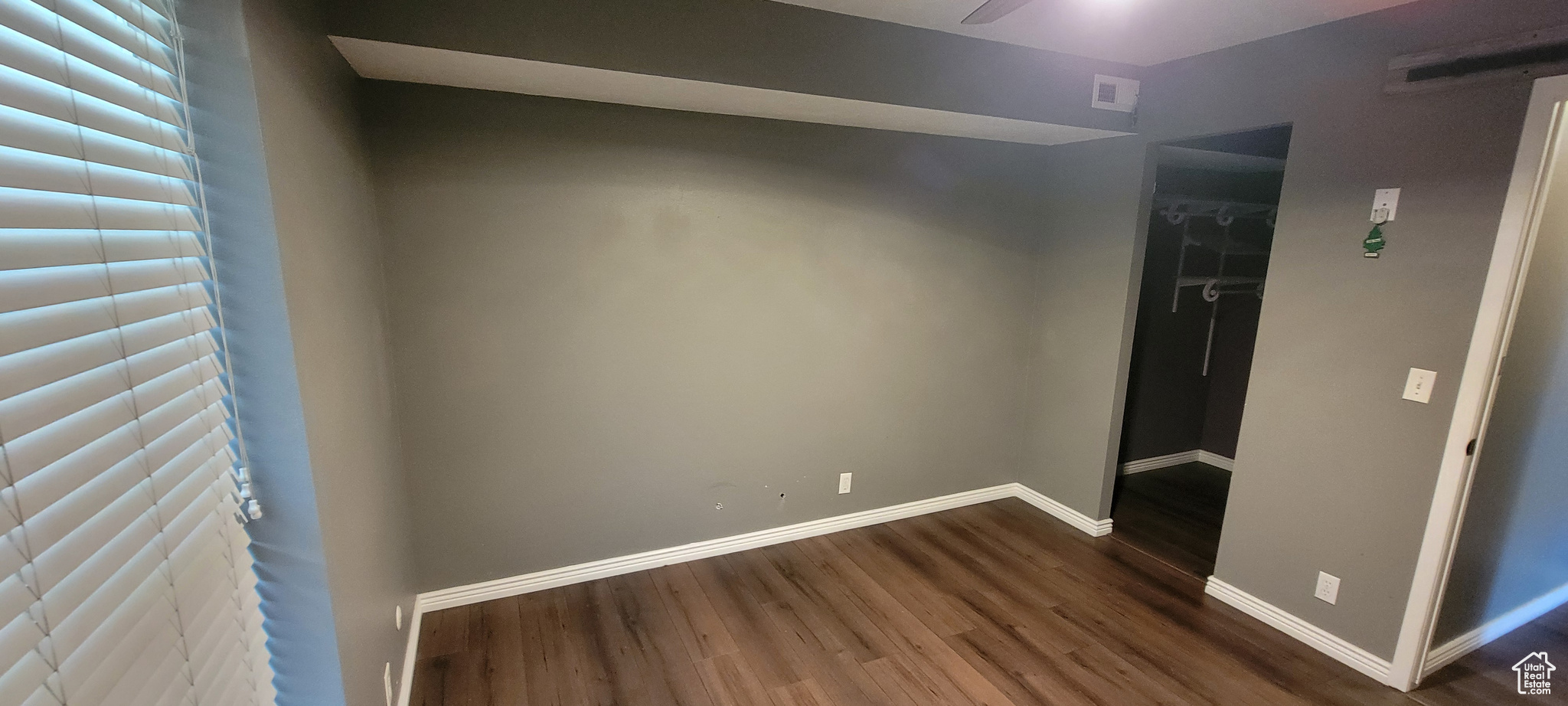 Unfurnished room featuring dark wood-type flooring