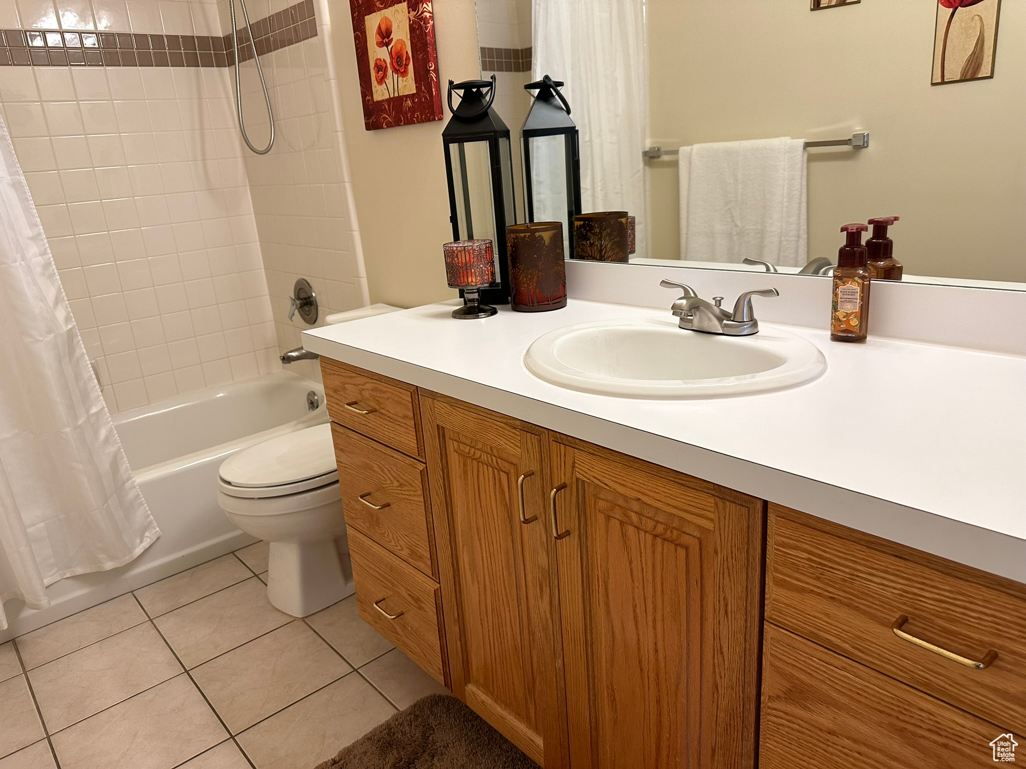 Full bathroom featuring shower / tub combo, tile patterned flooring, vanity, and toilet