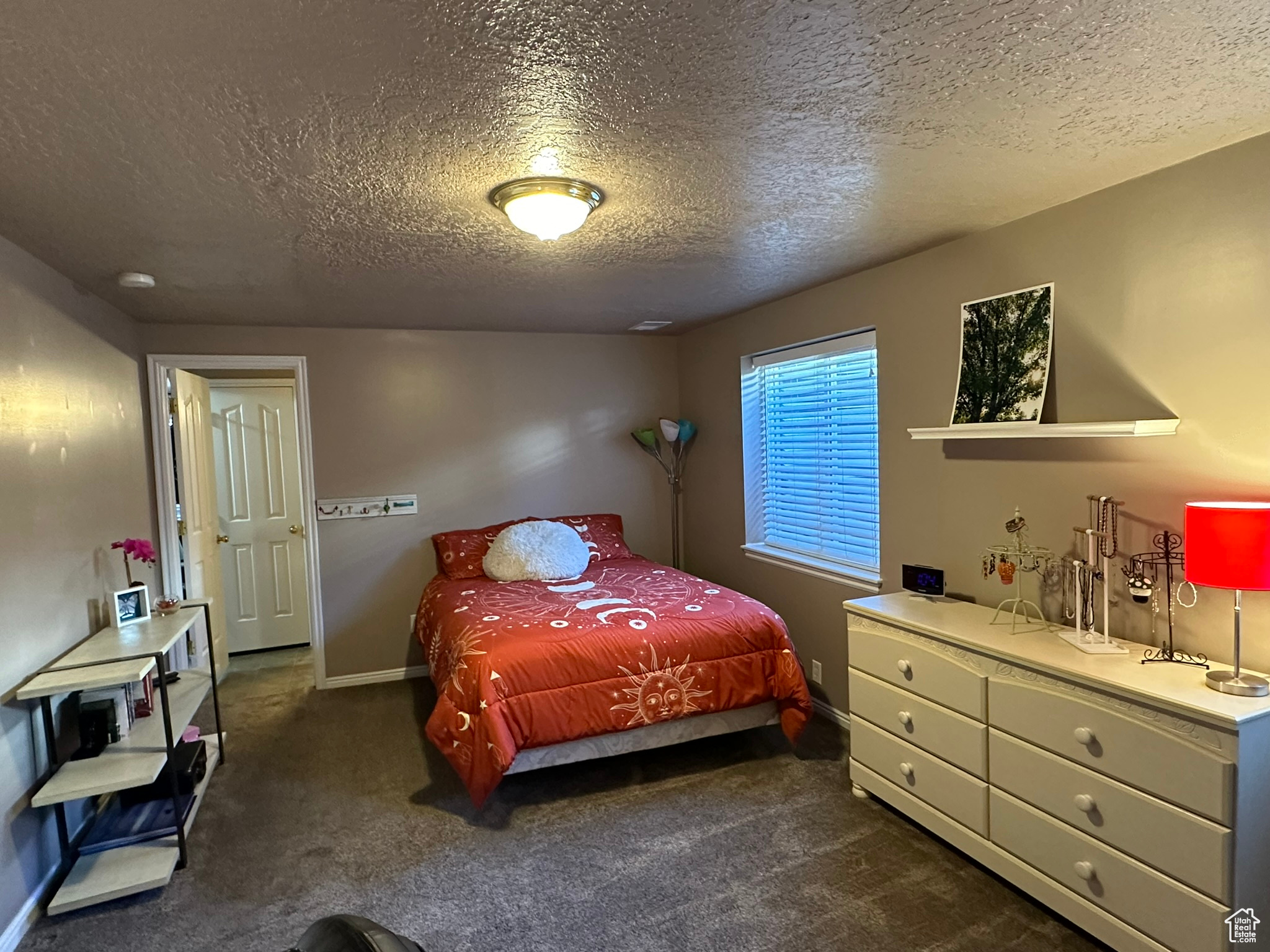 Carpeted bedroom with a textured ceiling