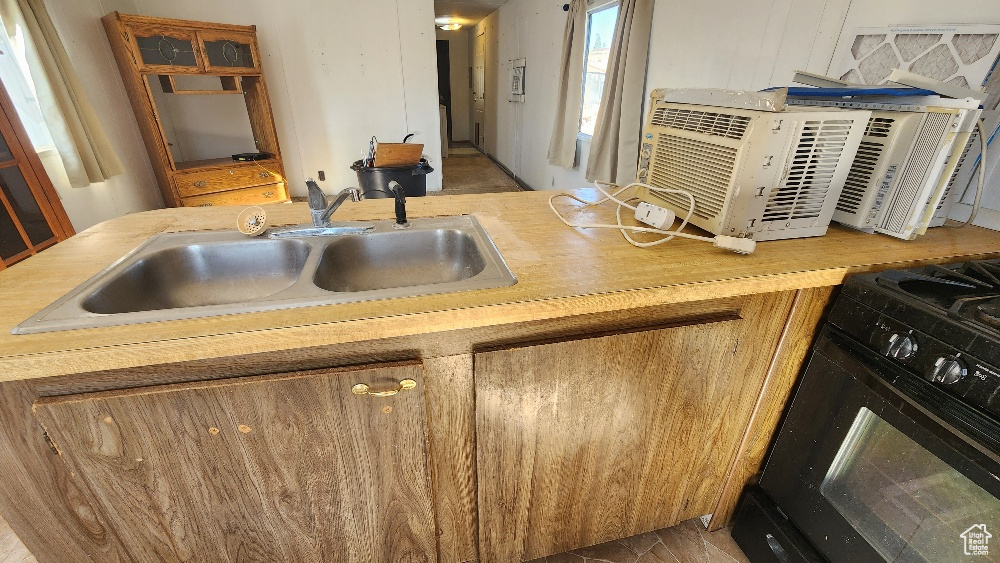 Kitchen featuring sink and black gas range