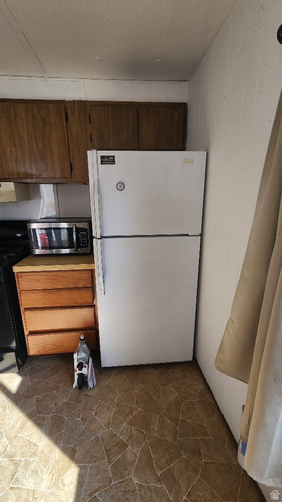 Kitchen with white fridge and range