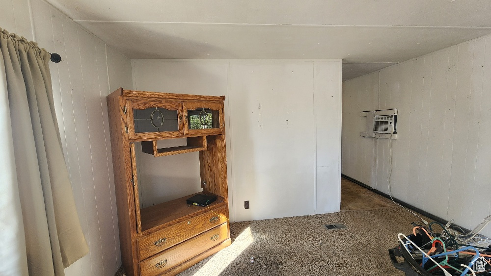 Interior space featuring carpet and a wall mounted AC