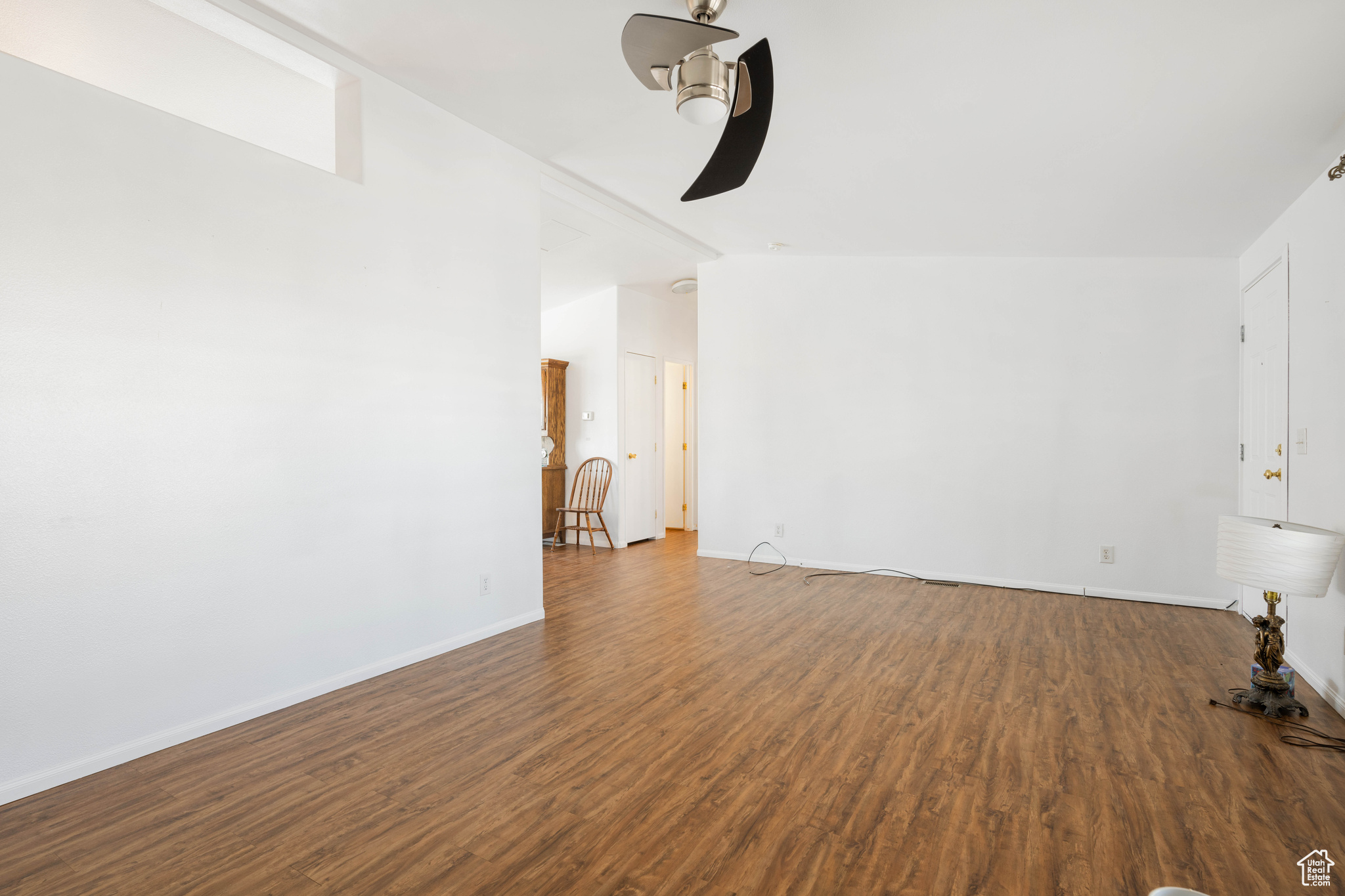 Unfurnished living room with ceiling fan and hardwood / wood-style floors