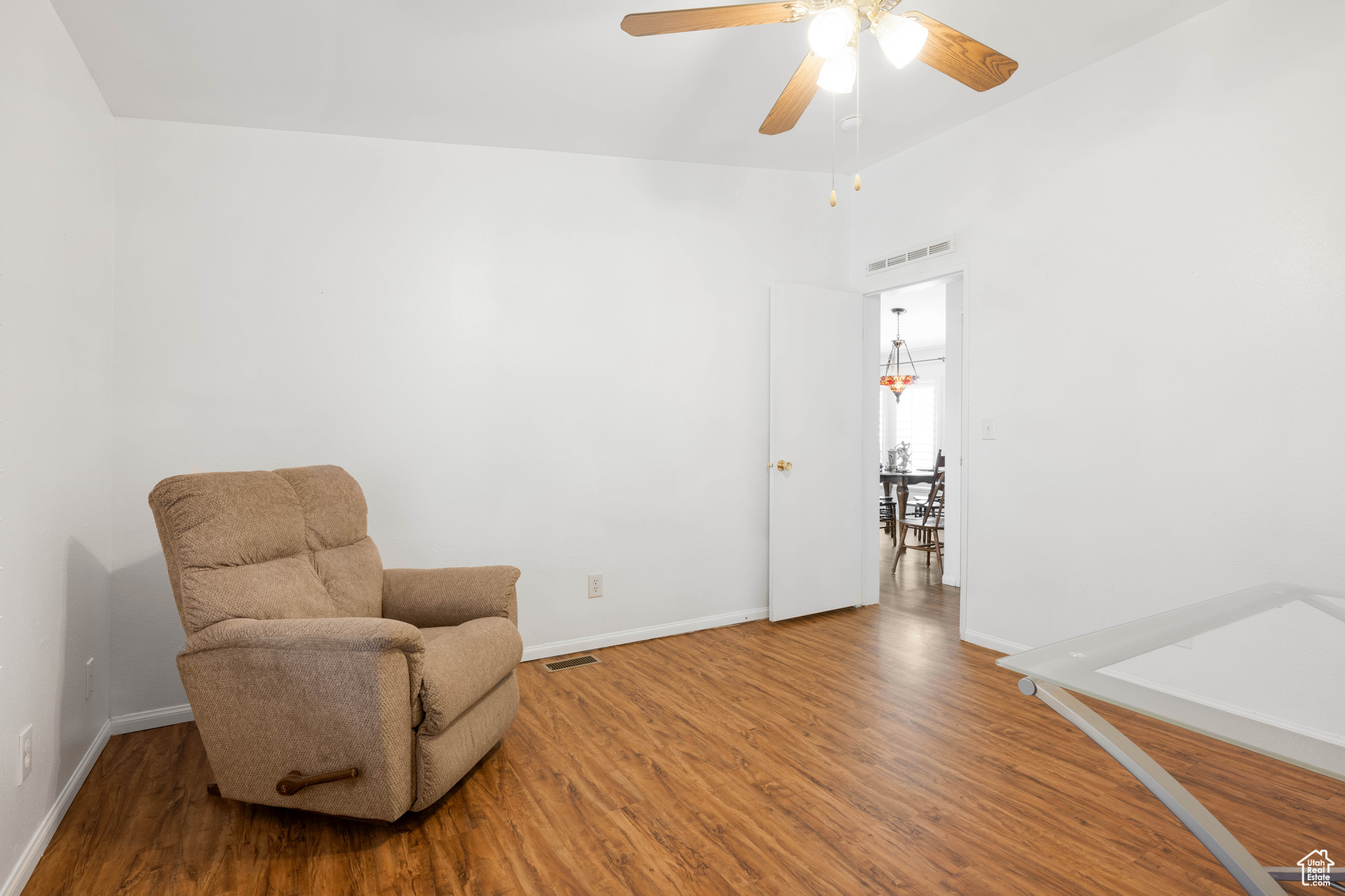 Sitting room featuring wood-type flooring and ceiling fan