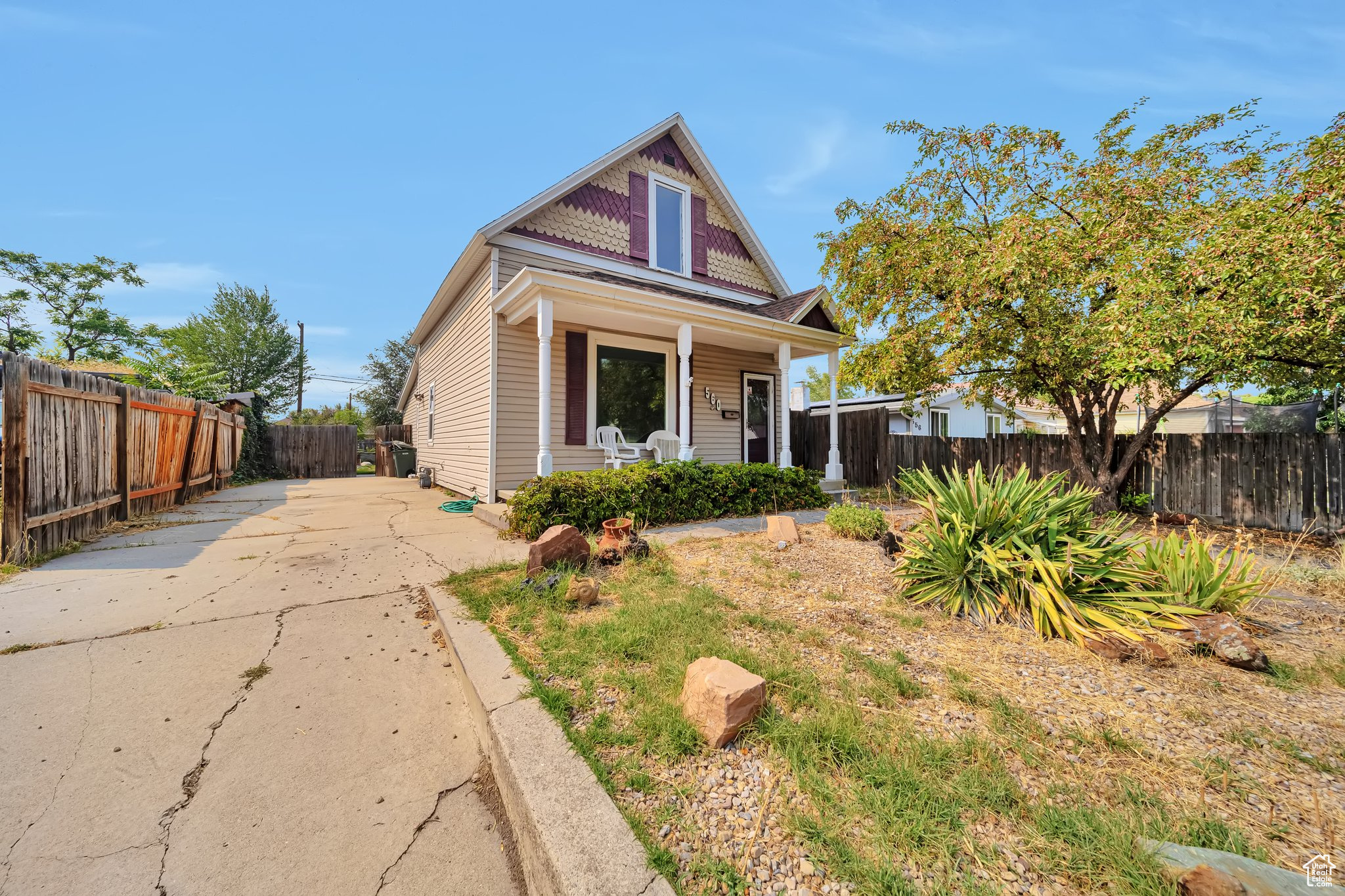 Front yard view of home with covered porch and driveway.