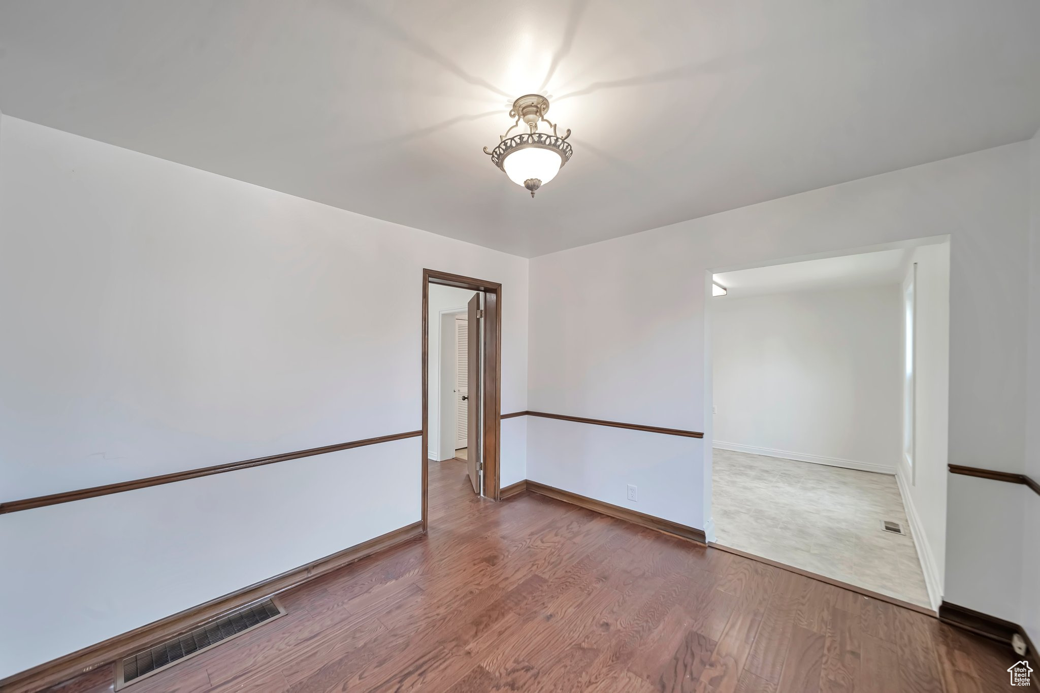 Formal dining looking into kitchen dining and master bedroom door.