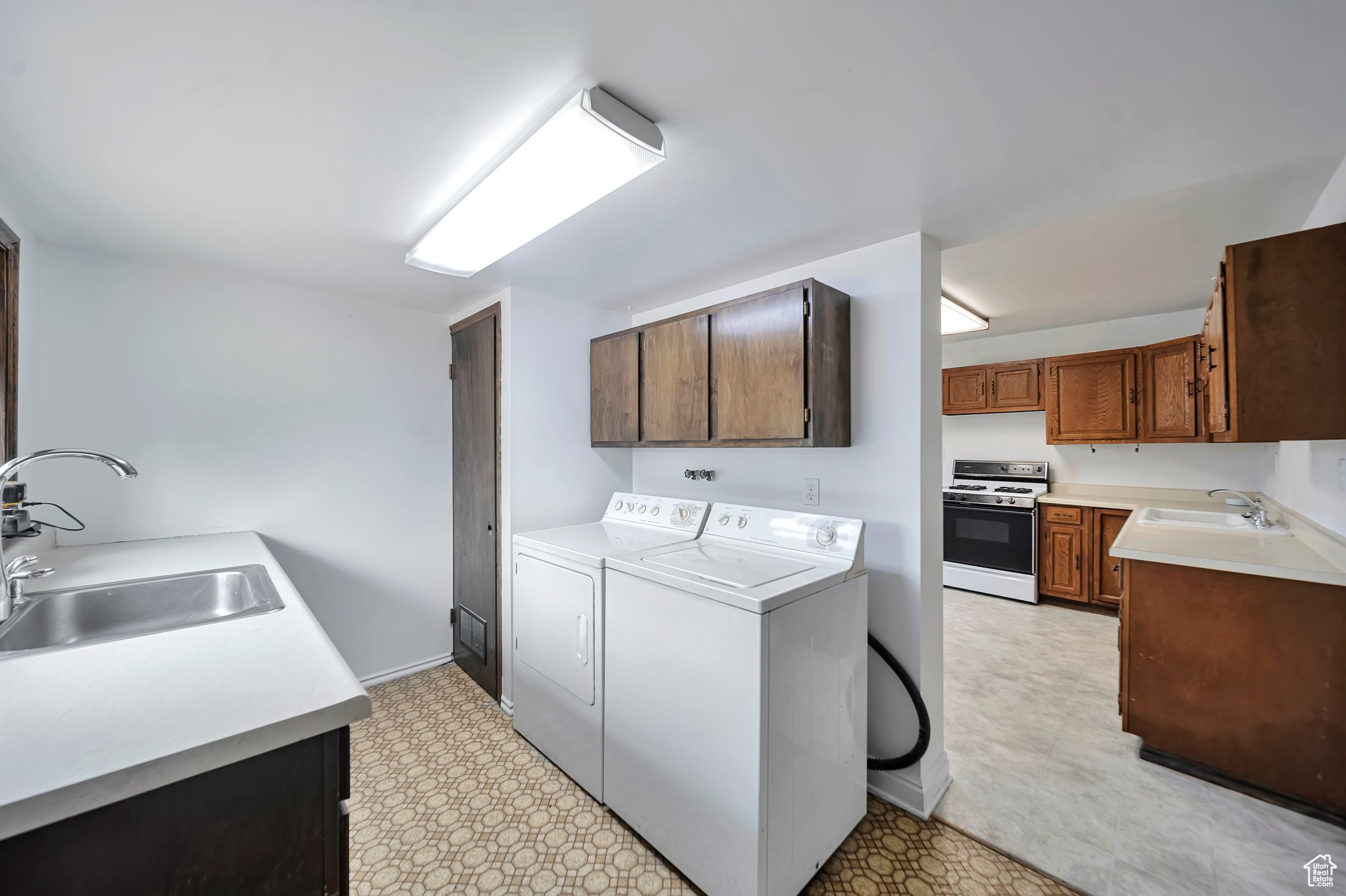 Main floor Laundry with extra sink and kitchen.