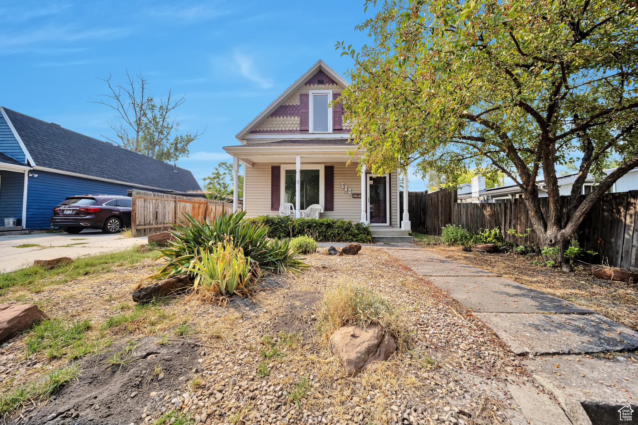 Front view of home view with xeriscape and covered porch area.