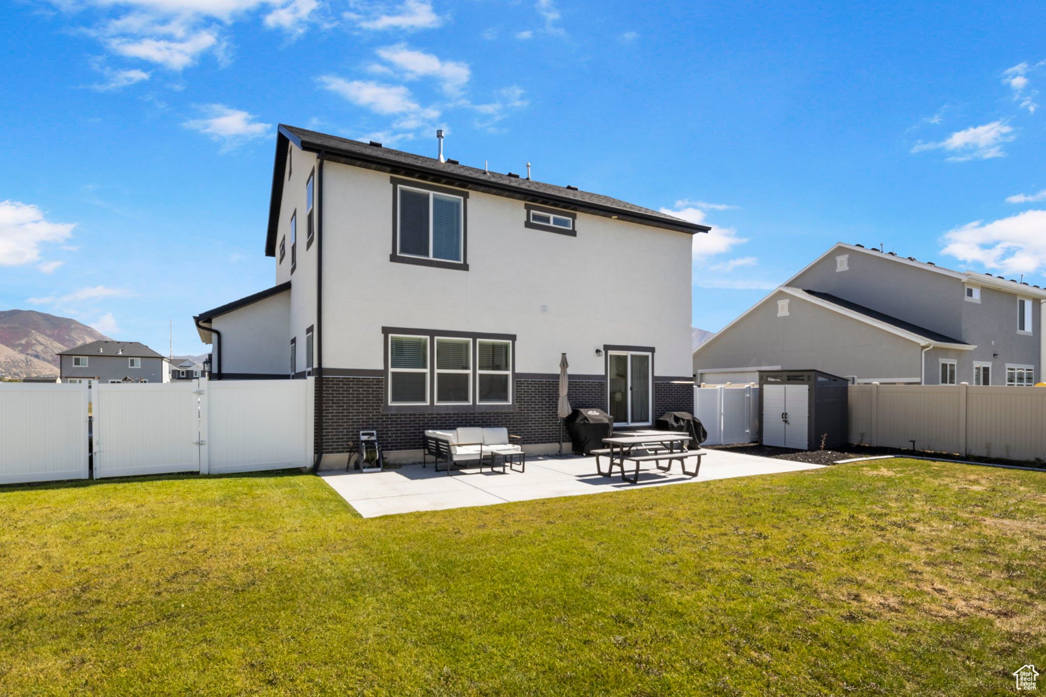 Rear view of property with a yard and a patio area