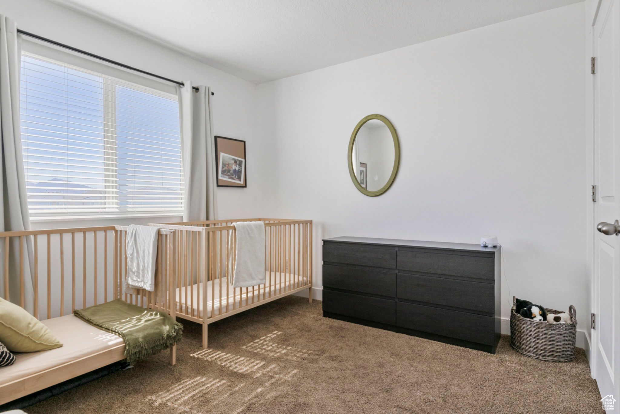 Carpeted bedroom with a crib