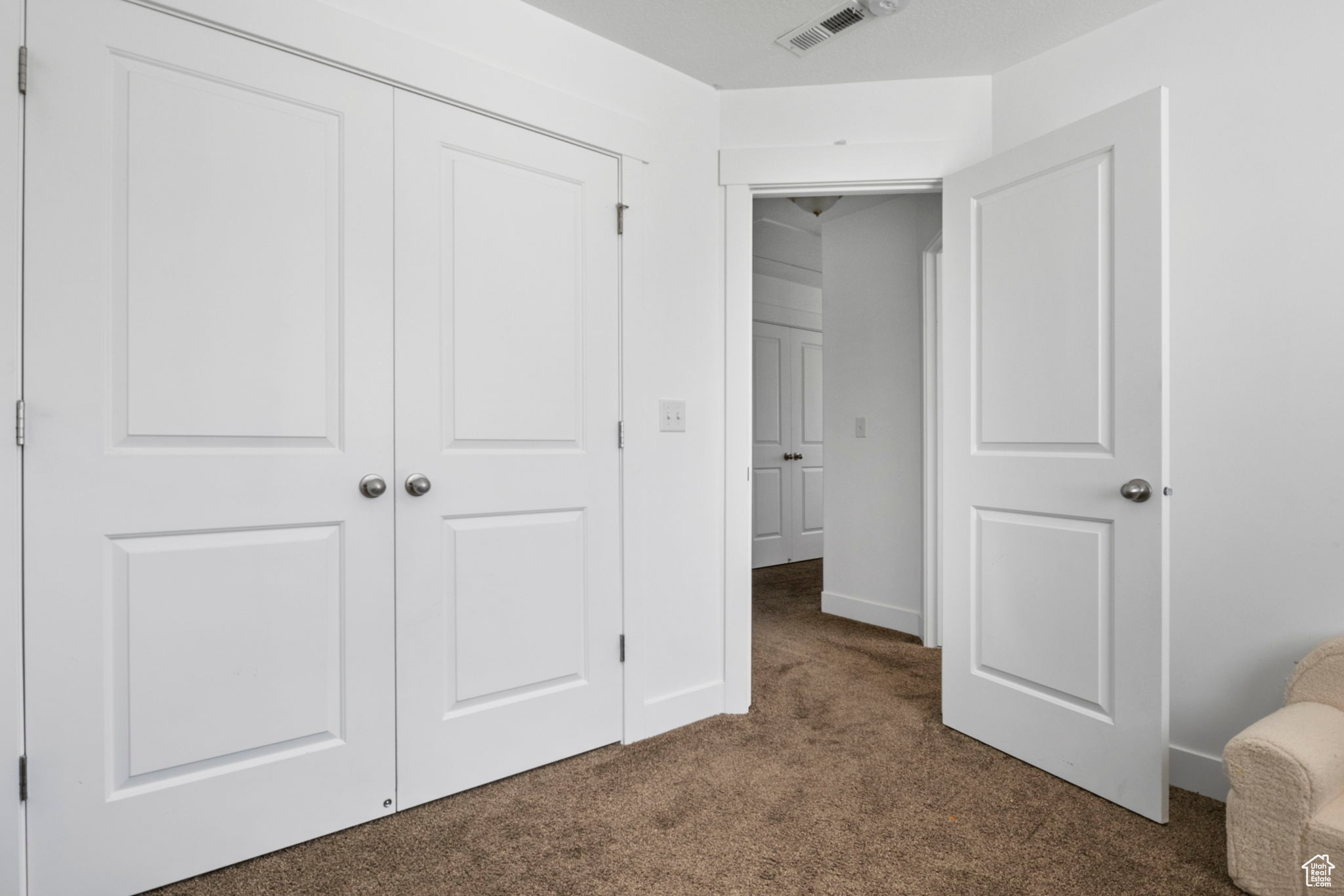 Interior space with a closet and carpet floors