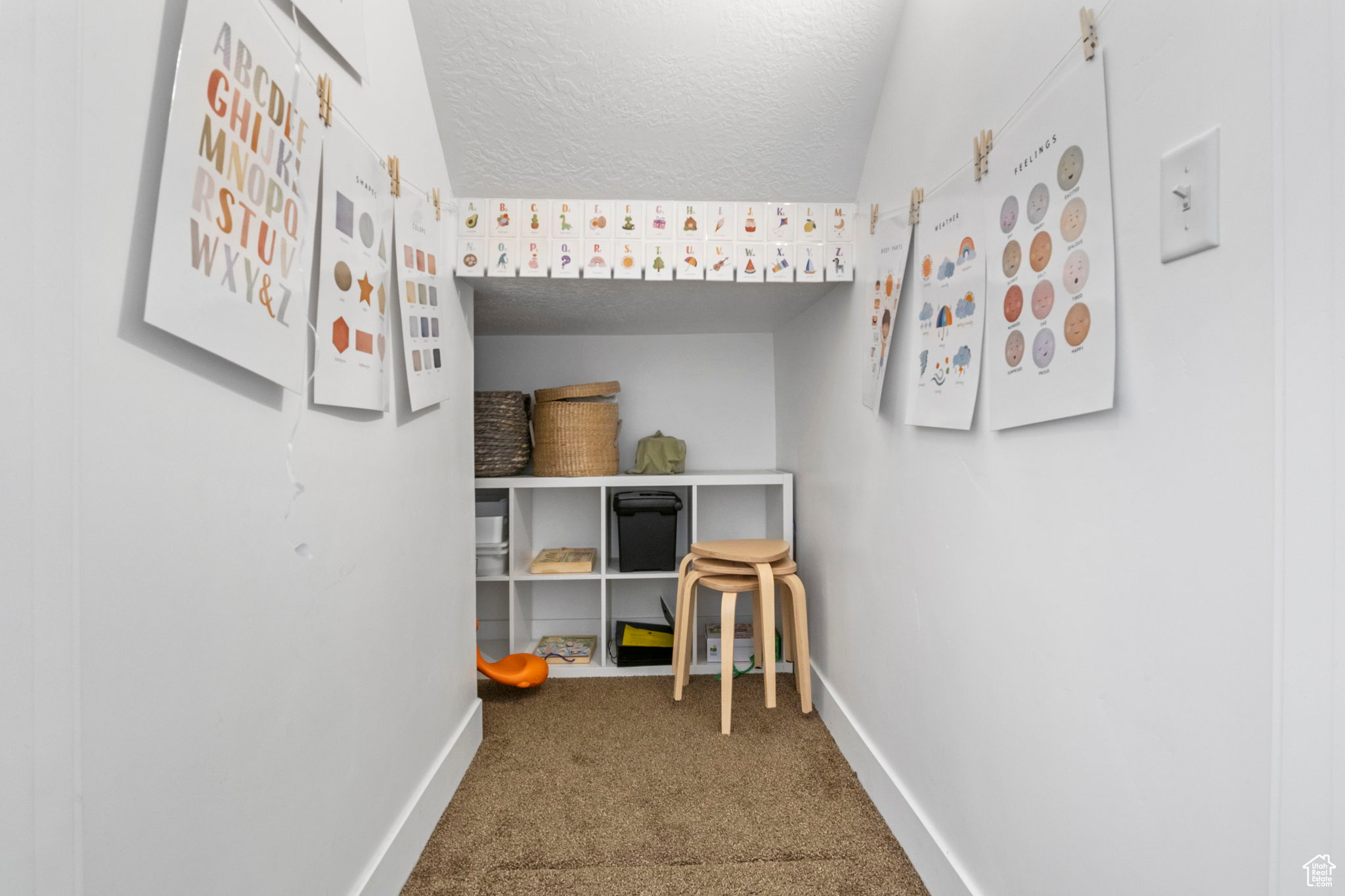 Interior space with a textured ceiling and carpet