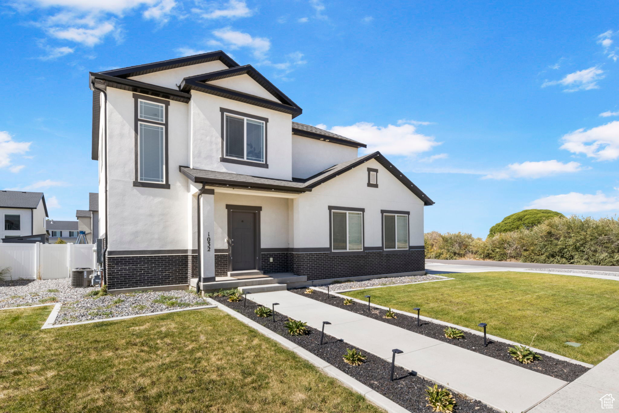 View of front of home featuring a front lawn and central air condition unit