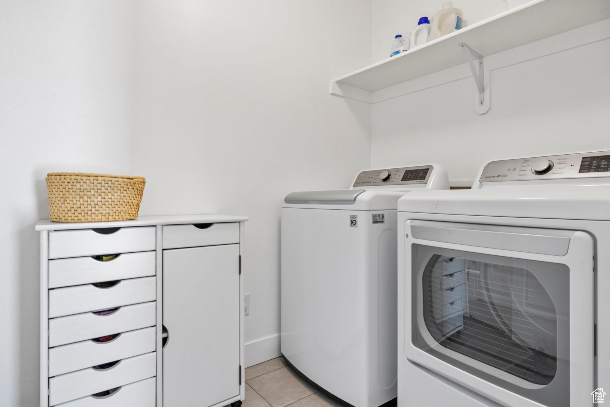 Laundry room featuring independent washer and dryer and light tile patterned floors