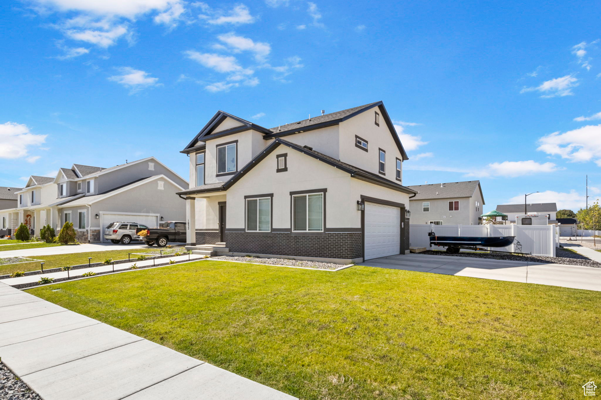 View of front of house with a garage and a front lawn