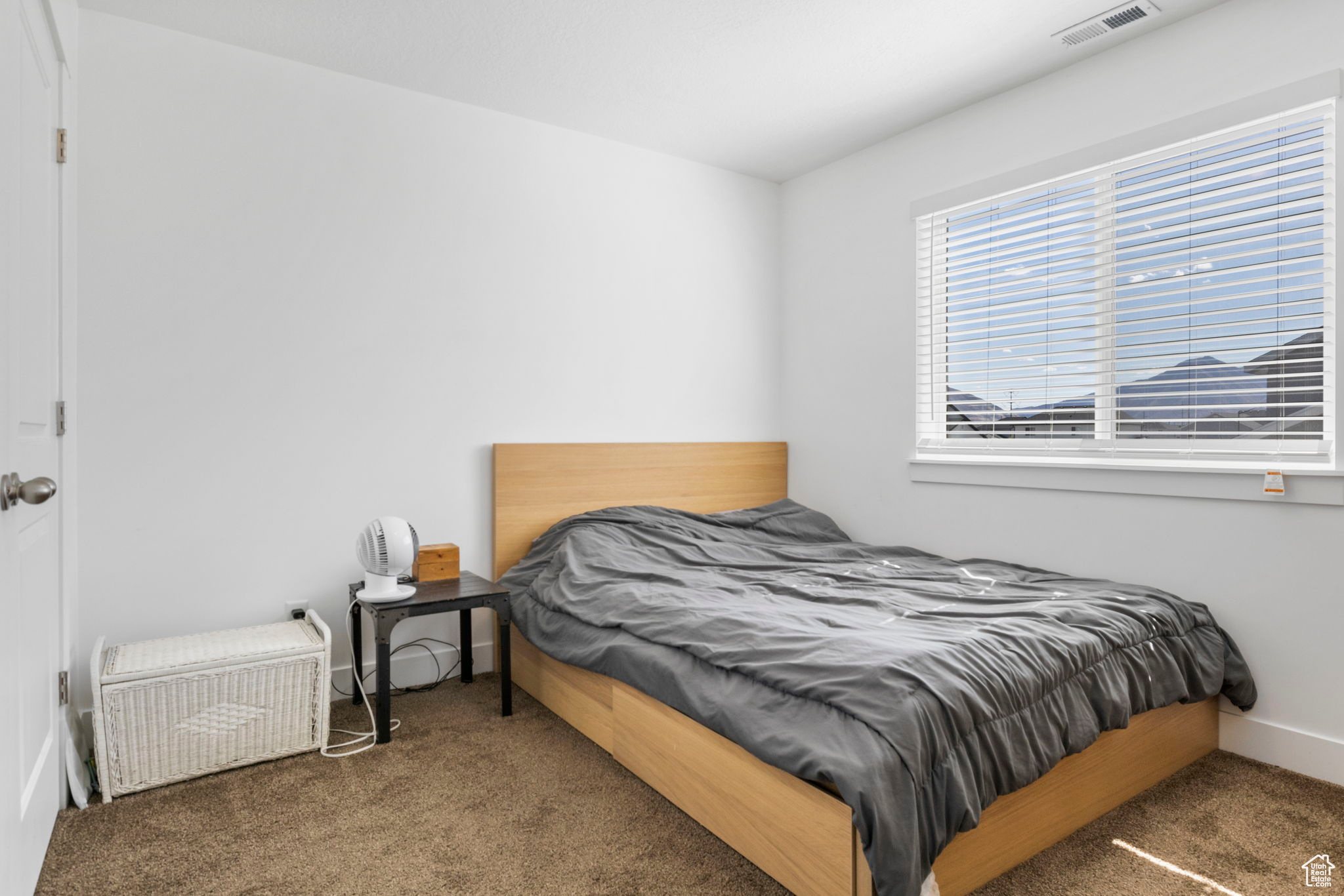 Bedroom with dark colored carpet