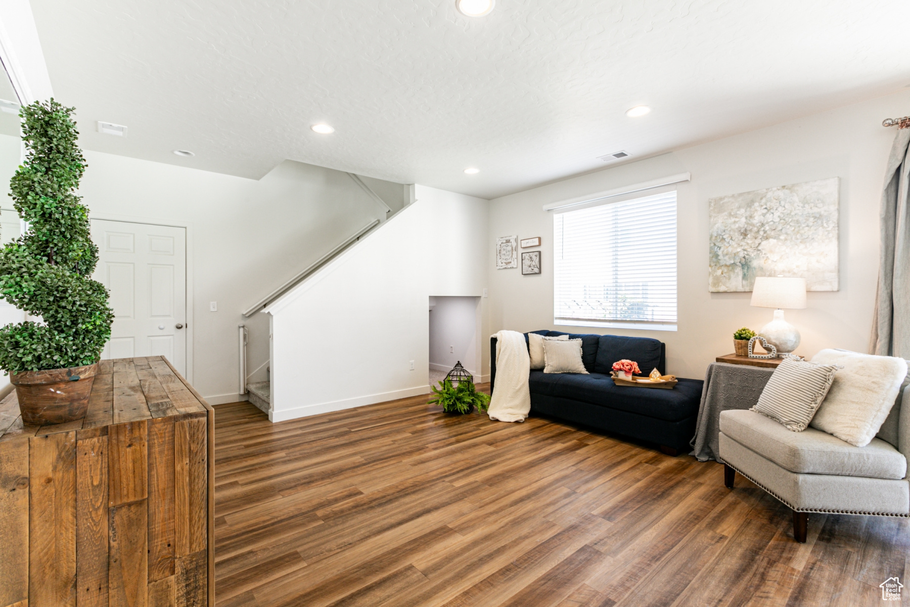 Living area with a textured ceiling and dark hardwood / wood-style floors