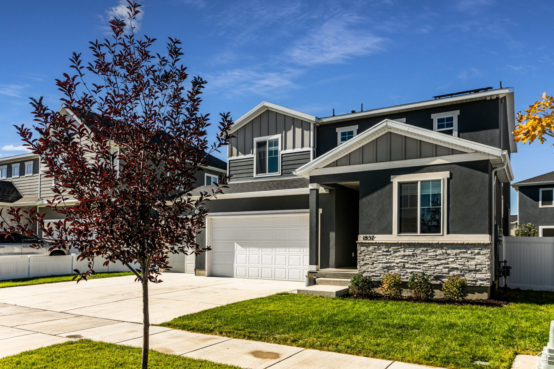 Craftsman-style home with a garage and a front yard